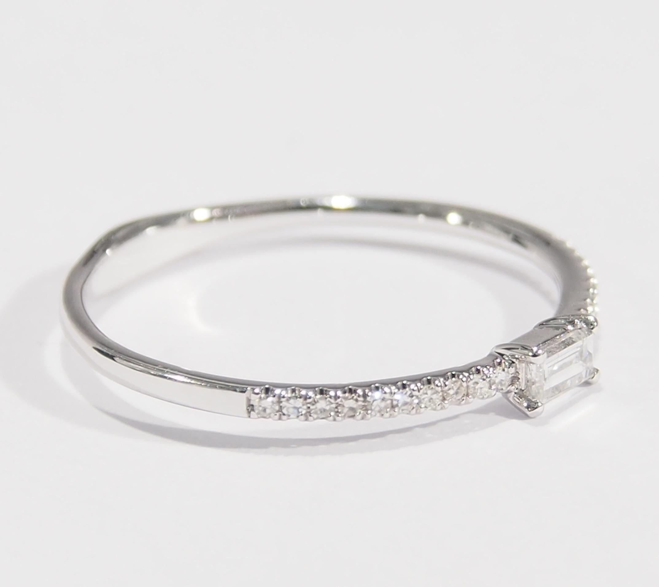 This is a delightful 18K White Gold Diamond Band Style Ring. There are (20) Diamonds, approximately 0.06ctw, G-H in Color, VS-SI in Clarity accenting (1) Baguette, approximately 0.09ct, G-H in Color, VS-SI in Clarity. The Ring is easily worn