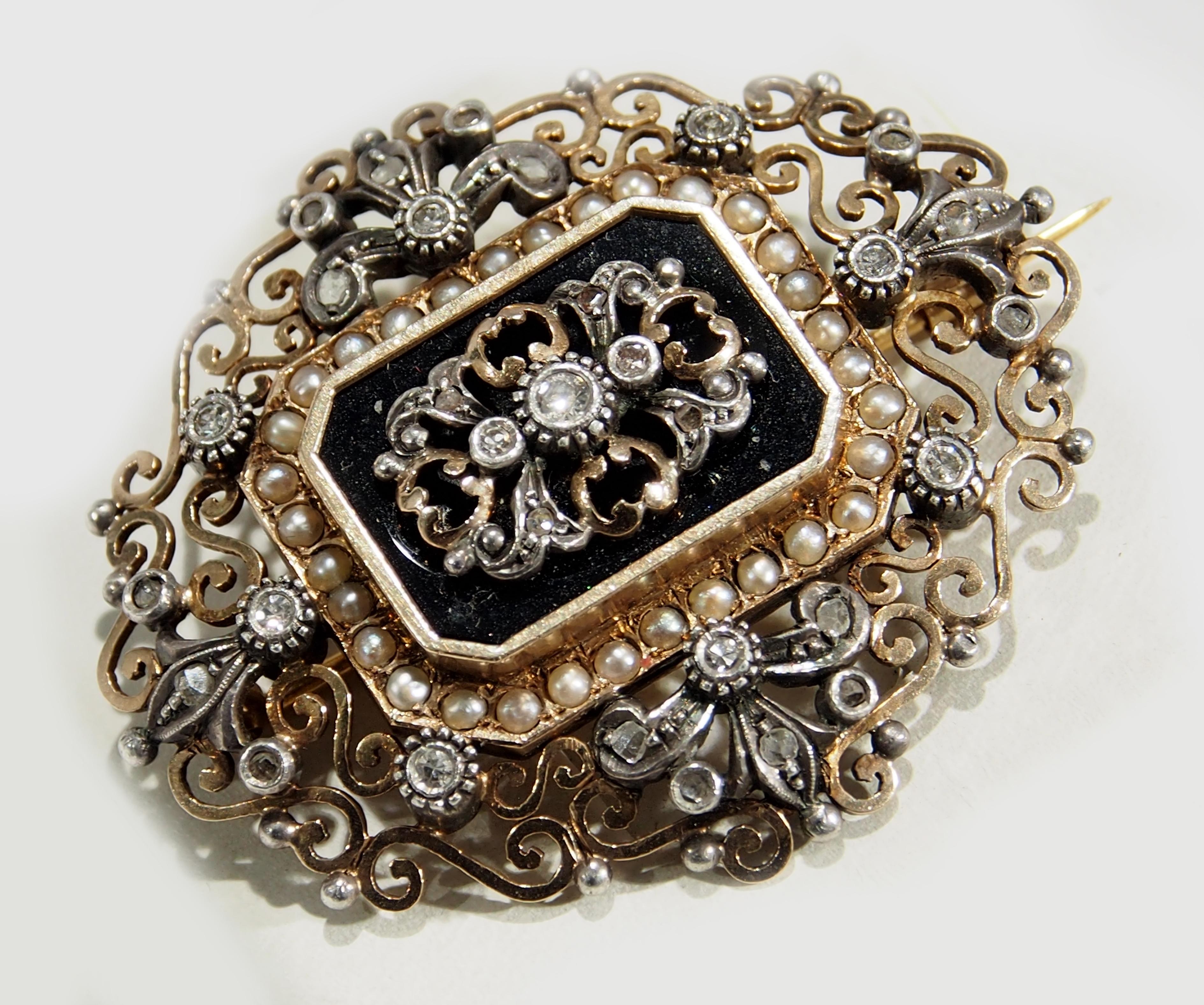 For the collector of fine Edwardian jewelry is this 18K Yellow and White Gold Pin/Brooch. This 1 3/4 inch in length Brooch is elegantly designed with scroll work in an oval shape. Contrasting the oval is an octagonal center Black Onyx framed by