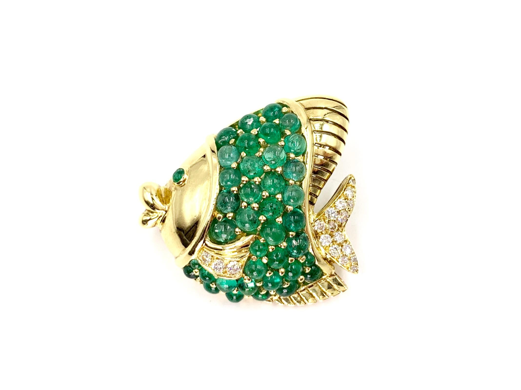 A whimsical and beautiful 18 karat yellow gold puckering fish pendant that doubles as a brooch. Fish contains 7.73 carats of cabochon genuine emeralds and .36 carats of white round brilliant diamonds. Diamond quality is approximately F color, VS2