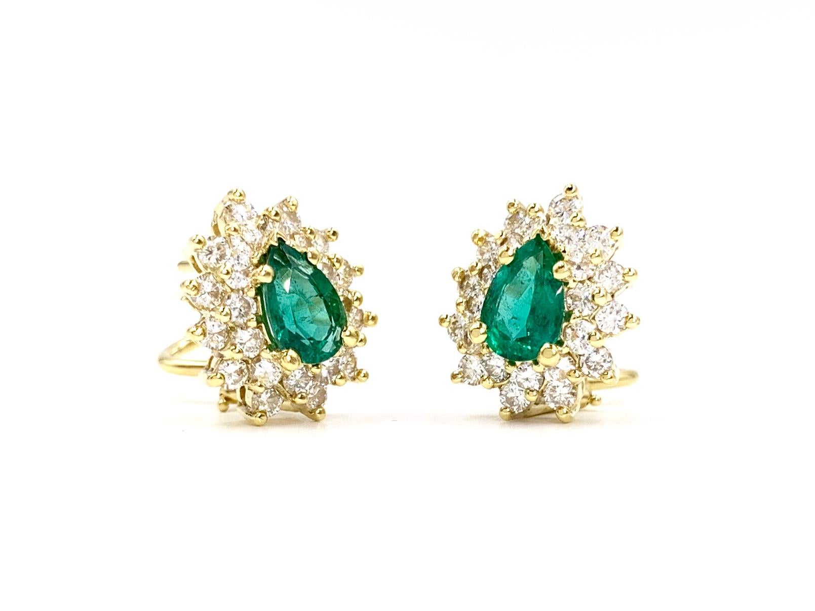 Classic and timeless 18 karat yellow gold pear shape emerald and diamond earrings by Martin Flyer. Earrings have a total emerald weight of 1.64 carats and total diamond weight of 1.85 carats. Pear shape emeralds have a beautiful make with excellent