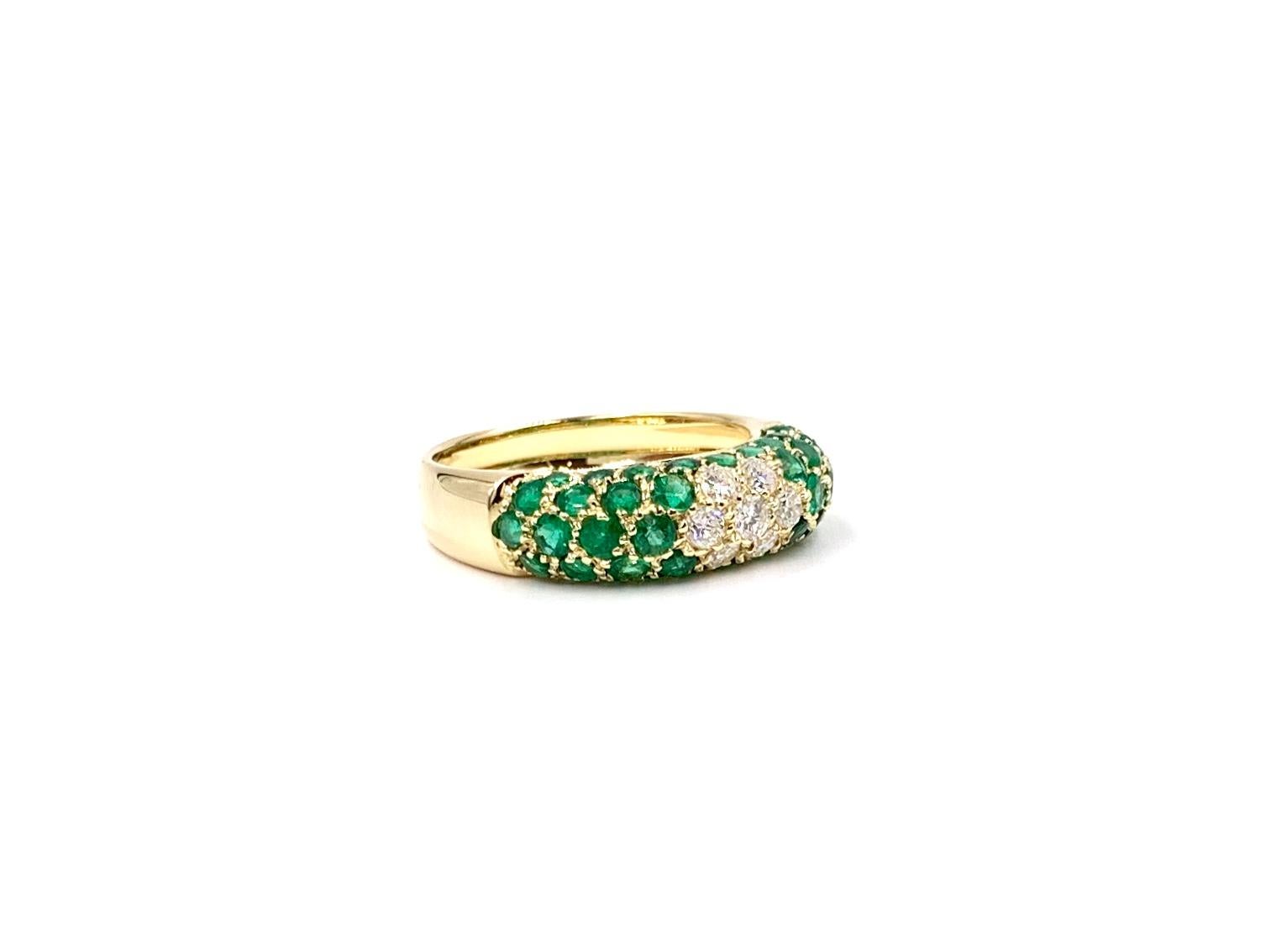 A beautiful and wearable 18 karat yellow gold Italian made slightly domed 6mm wide band ring featuring 2.47 carats of vivid, well saturated green emeralds and .40 carats of high quality round diamonds. Diamond quality is approximately F color, VS2