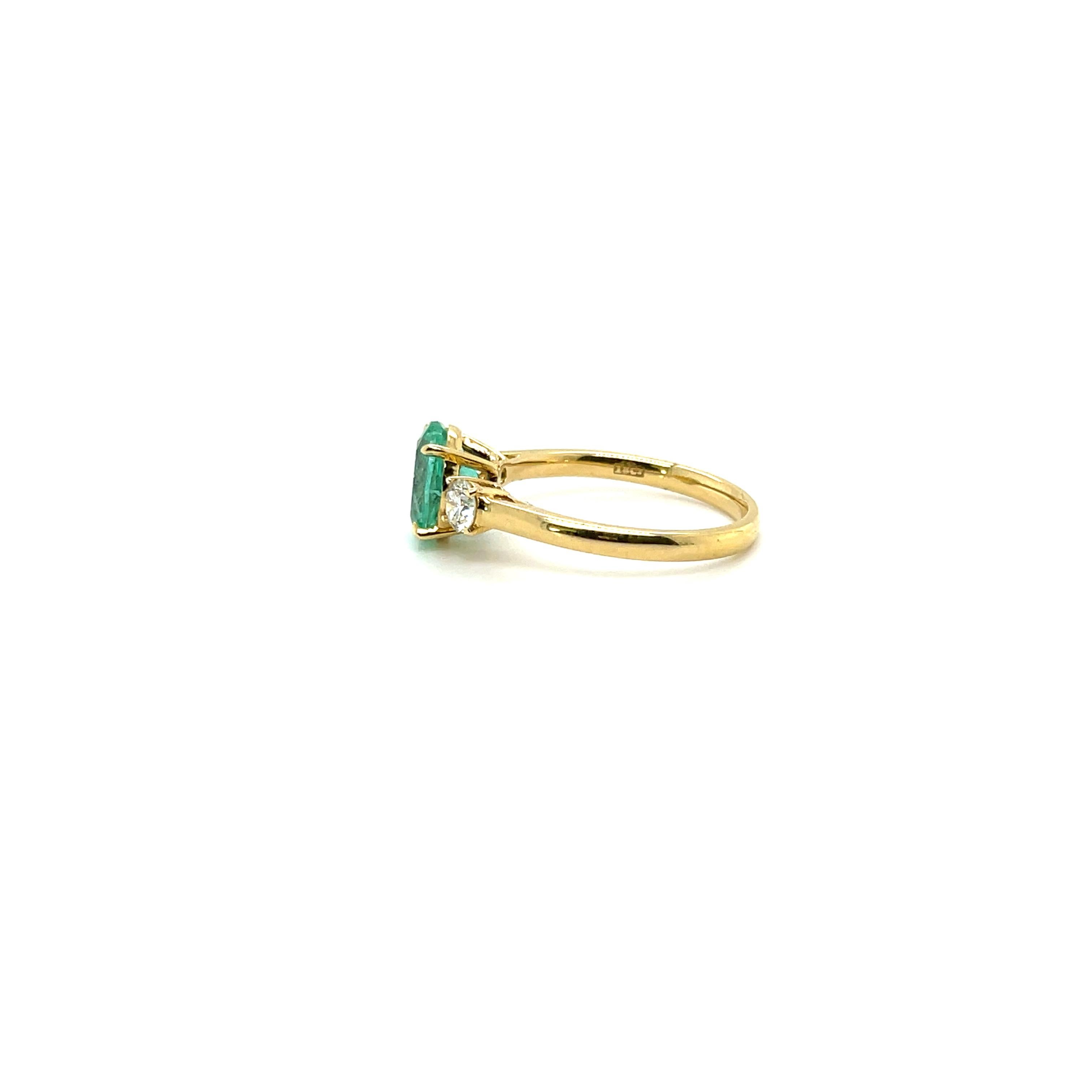 Beautiful Colombian Emerald and Diamond trilogy ring, gorgeously crafted in eighteen karat yellow gold and complimented by a stunning polished finish design.

One ladies - 18ct yellow gold three stone ring, narrow, half round shank with underrail,