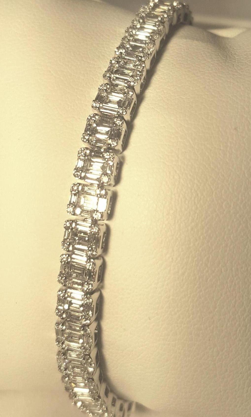 Brand new.  Genius of design here is an understatement.  Fabricated in 18 karat white gold this fabulous bracelet appears at first glance to contain 30 one carat emerald cut diamonds.  Now the genius...Rather than 30 diamonds, there are a total of