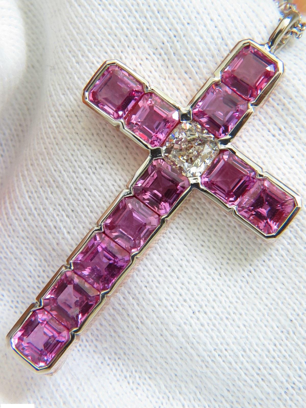 Prime Cross

GIA 1.01ct. Cushion Cut Diamond

Report# 5141777173

K-color Si-1 clarity



9.00ct. Natural Ascher cut Pink Sapphires

Clear Clarity & Amazing Transparency.



Additional diamonds on chain:

.40ct. Rounds, full cut.

H-color, Vs-2