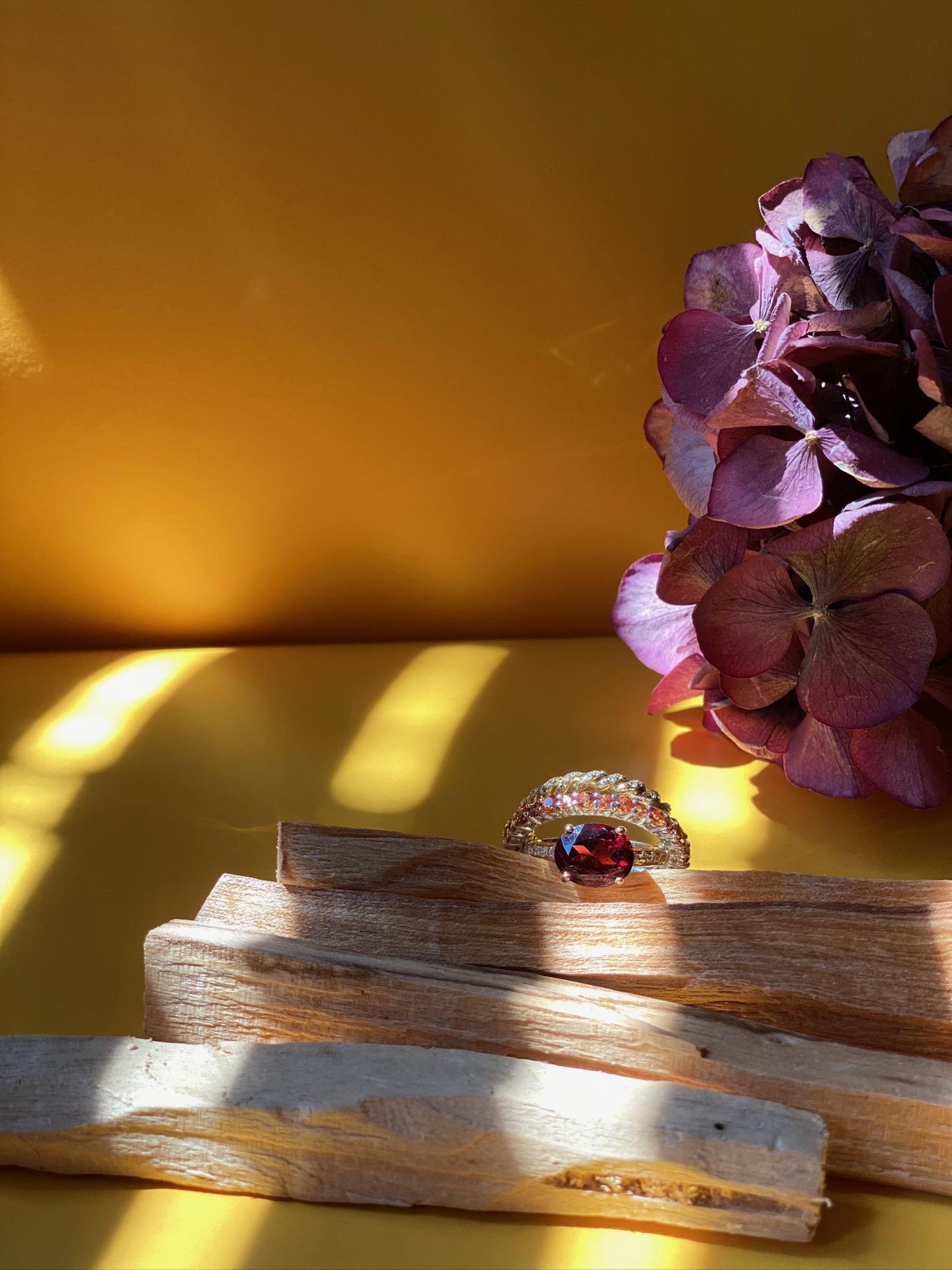 18 Karat Gold 0.23 Karat Diamonds 3 Karat Tangerine Sapphires Garnet Ring
Here there is an amazing Aura ring, handcrafted with pure 18 karats yellow gold adorned with deep red garnet and powerful 3 karat tangerine sapphires and 0.23 karat white