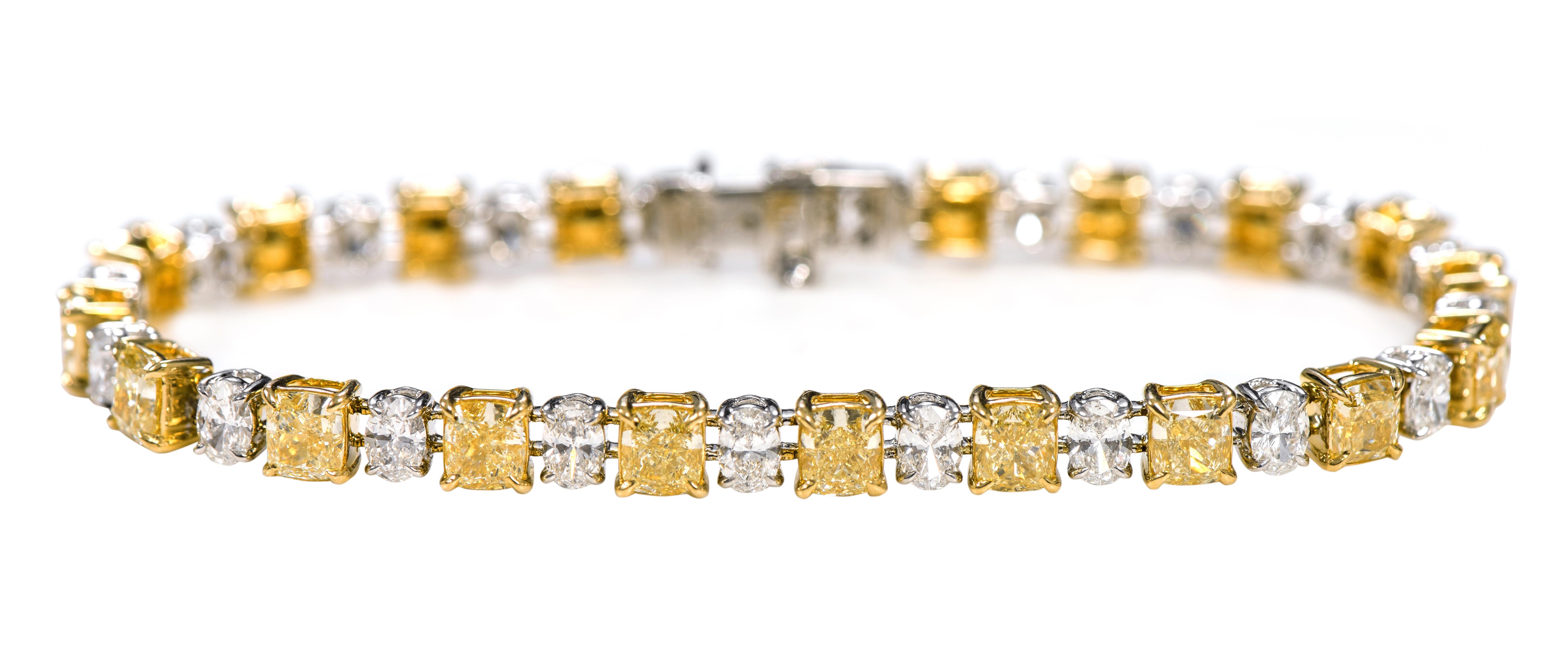 18 Karat Gold 11.21 Cushion-Cut Solitaire Fancy Yellow and White Diamond Statement Tennis Bracelet

This glorious canary and white diamond solitaire tennis bracelet is masterful. The solitaire 60 pointers yellow canary diamond cushion in a yellow