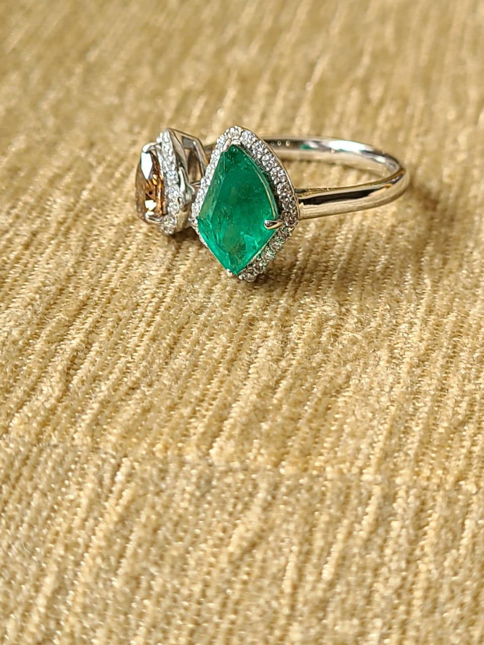 A very beautiful fancy shaped Emerald & Brown Diamond Cocktail Ring set in 18K White Gold. The Emerald weighs 1.17 carats and is of Zambian origin. The Emerald is completely natural, without any treatment. The weight of the Diamonds is 0.87 carats.