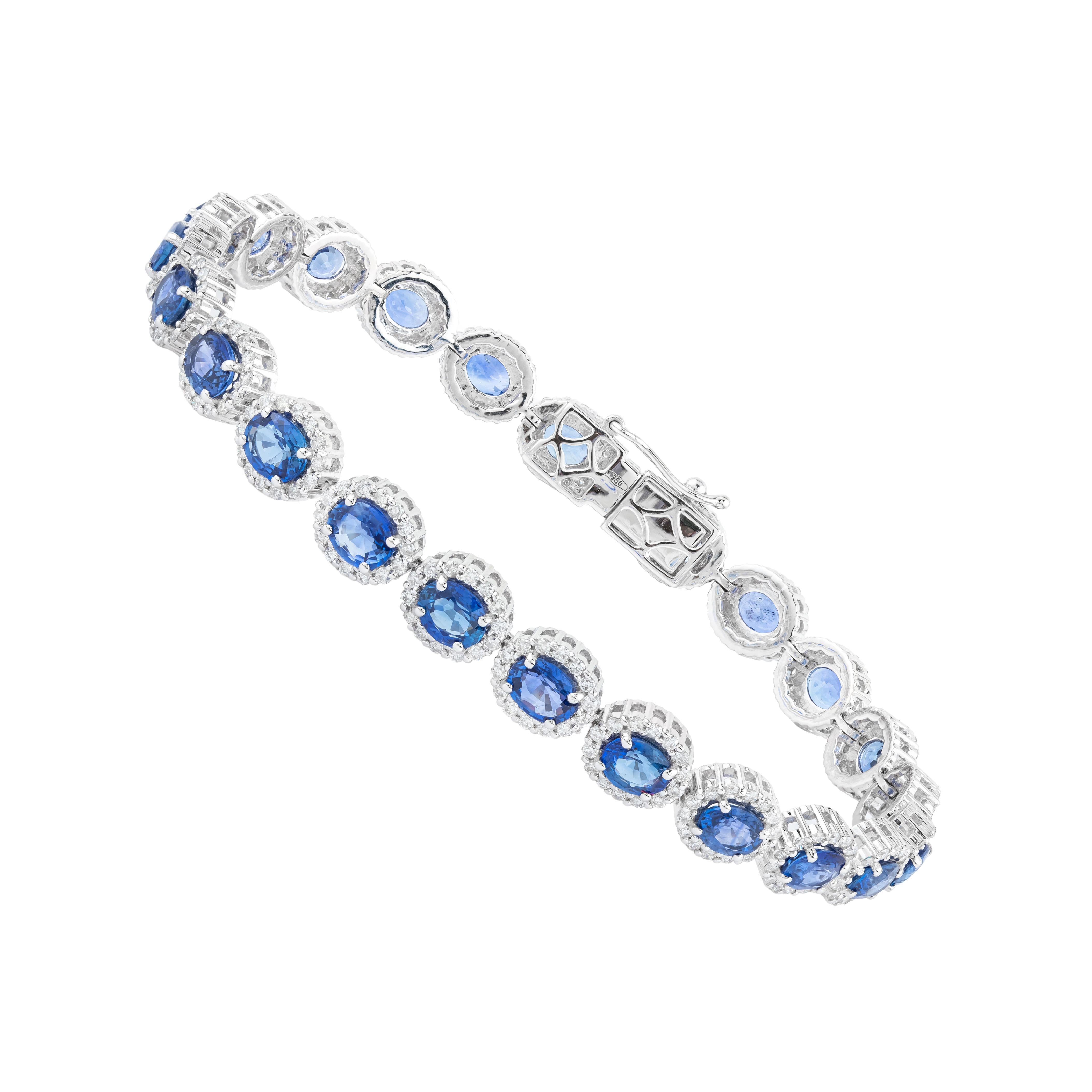 An exquisite blend of elegance and craftsmanship, the 18 Karat Gold Tennis Bracelet features a striking arrangement of 12.03 carats of sapphires and diamonds. Each sapphire is meticulously cut to showcase its rich depth, paired with brilliant-cut
