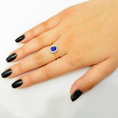 18 Karat Gold 1.28 Carat Natural Oval Blue Sapphire Ring with 16 VS/G Diamonds