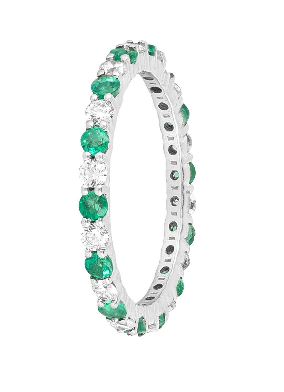 Immerse yourself in the allure of the 18 Karat Gold 1.34 Carat Diamond and Emerald Brilliant Cut Eternity Band Ring. This carefully crafted piece embodies the fusion of sophistication and elegance, showcasing a harmonious blend of brilliant diamonds