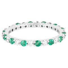 Bague éternité en or 18 carats, sertie d'un diamant de 1,34 carat et d'émeraudes taille brillant