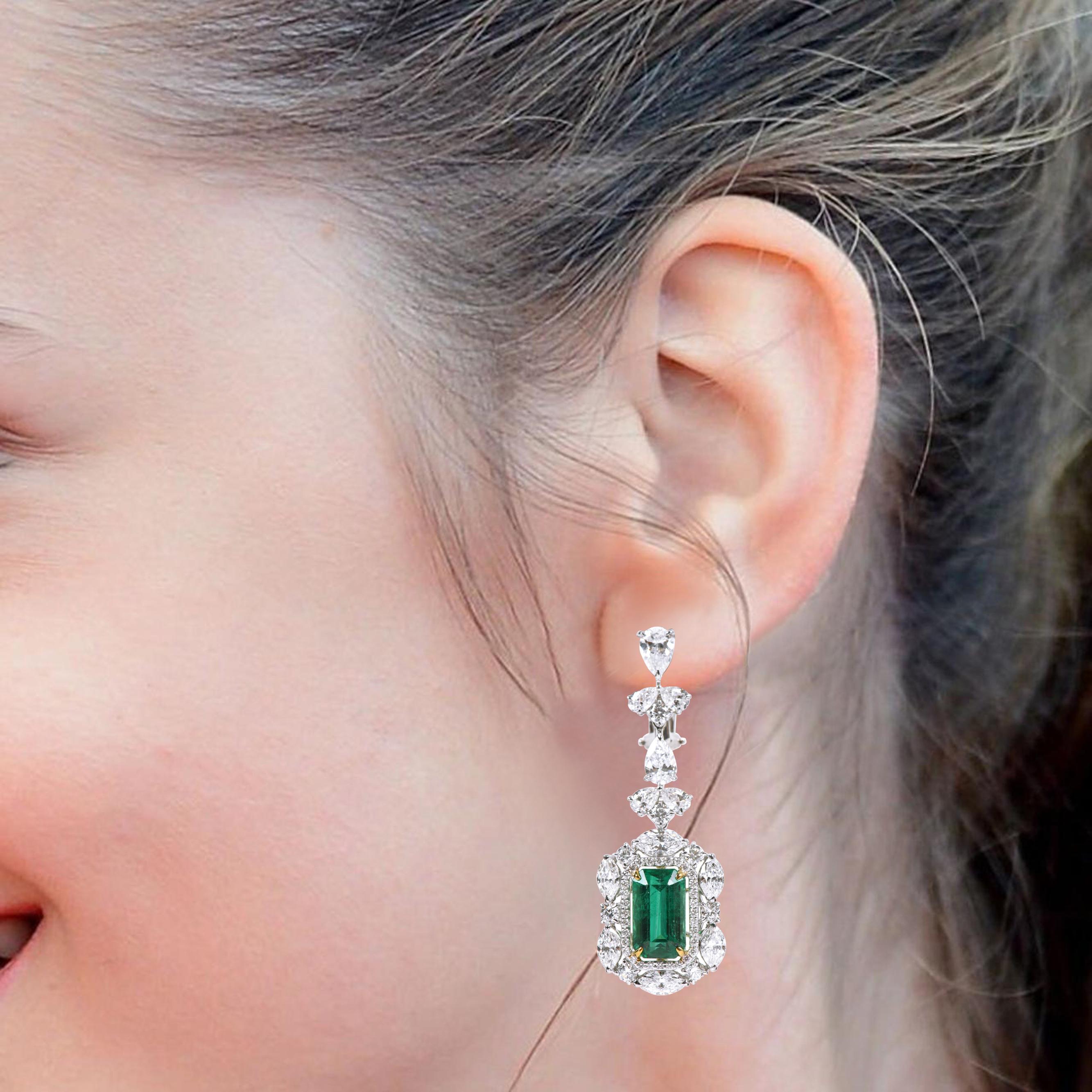 18 Karat White Gold 14.37 Carat Natural Emerald and Solitaire Diamond Cocktail Earrings

Showcasing pure artistry and craftsmanship, these majestic drop earrings are a treat and will impart an imperial touch to any look. Intricately designed with