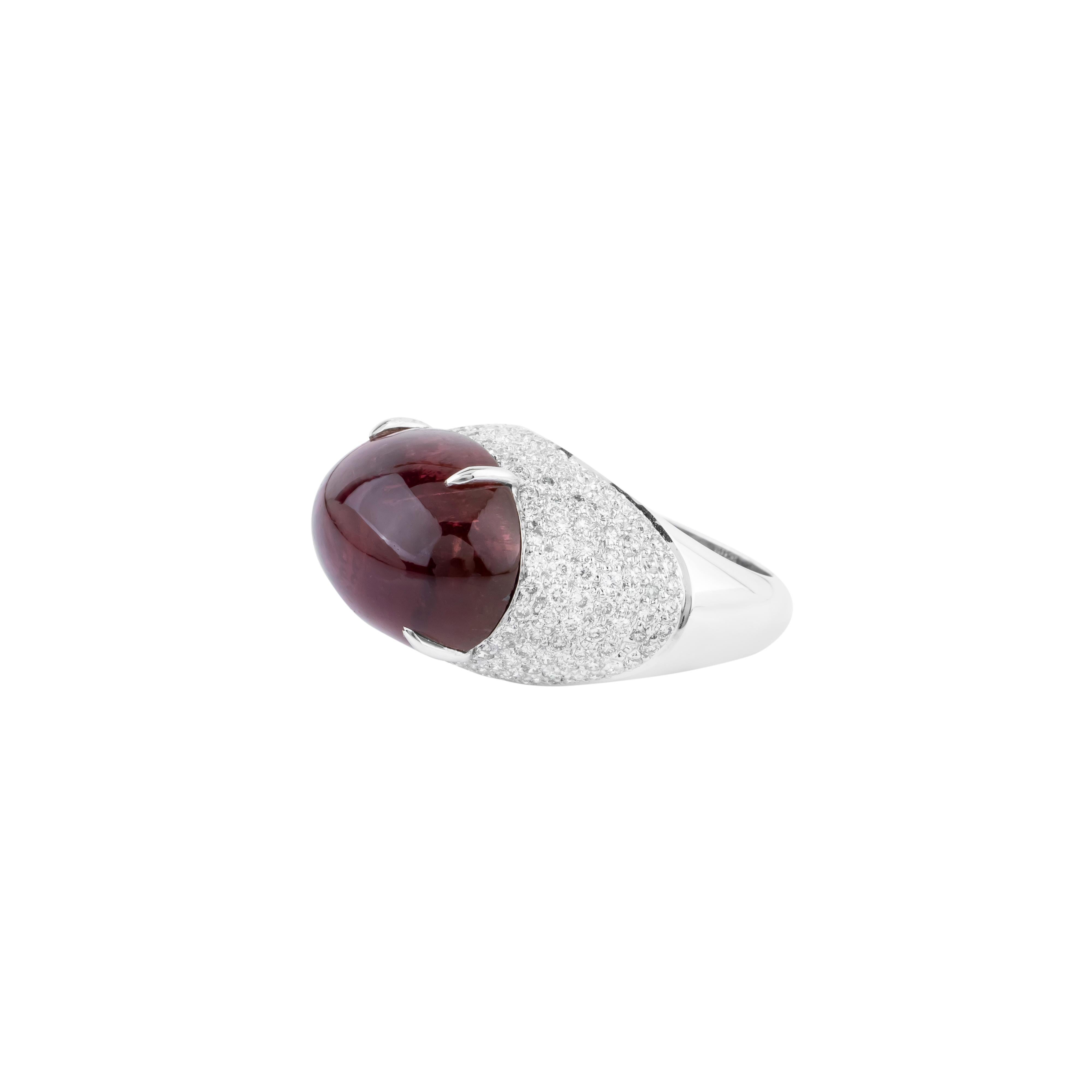 This 18 Karat Gold Solitaire Ring is a true testament to the splendor of nature’s finest gems and exceptional artistry. At the center of the design, a 15.57-carat tourmaline sits proudly, its striking presence captivating the eye with its vibrant