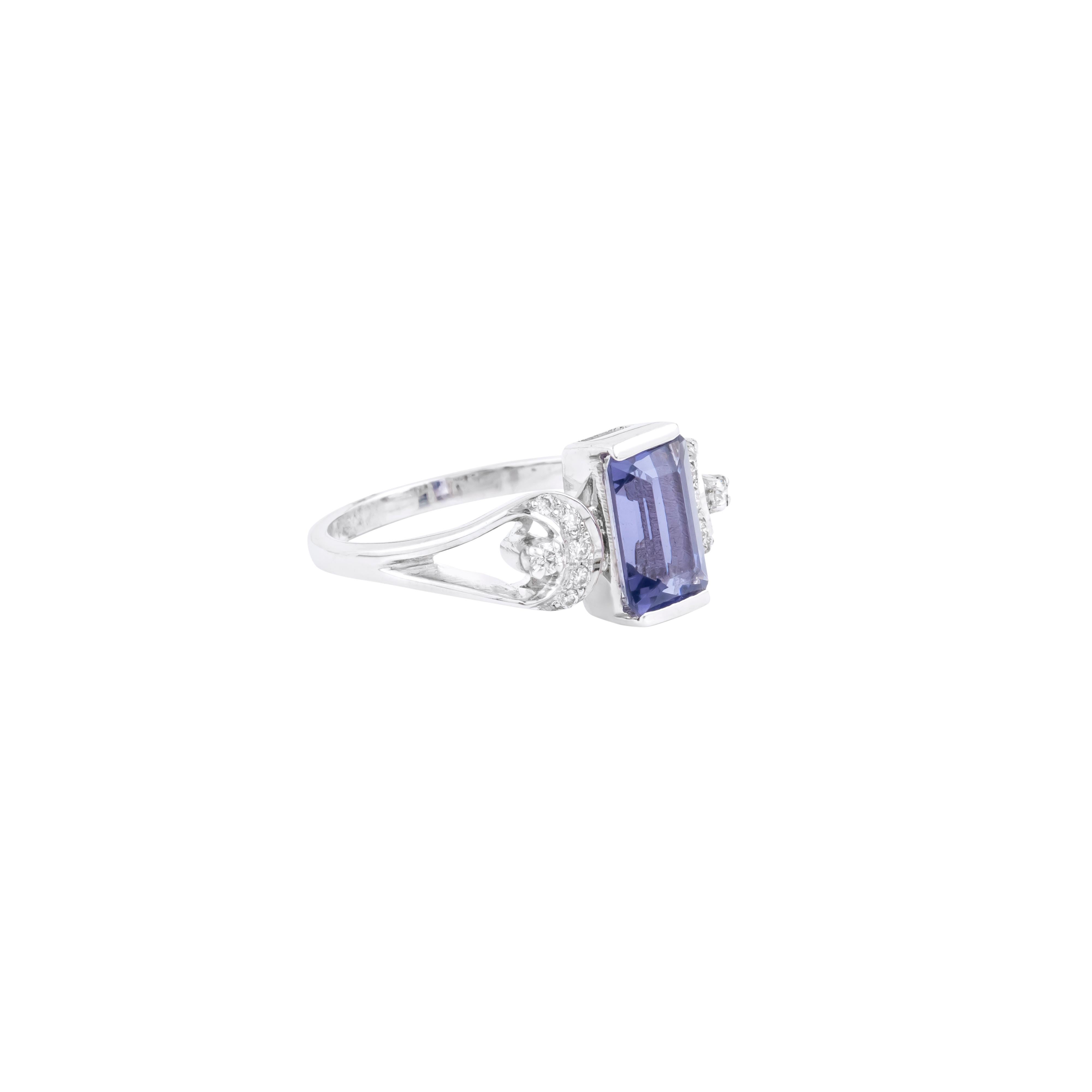 A 1.66-carat iolite serves as the centerpiece of this 18 Karat Gold cocktail ring, captivating with its enchanting depth and brilliance. The expertly faceted gemstone is mounted in a sleek prong setting, allowing it to radiate its natural allure