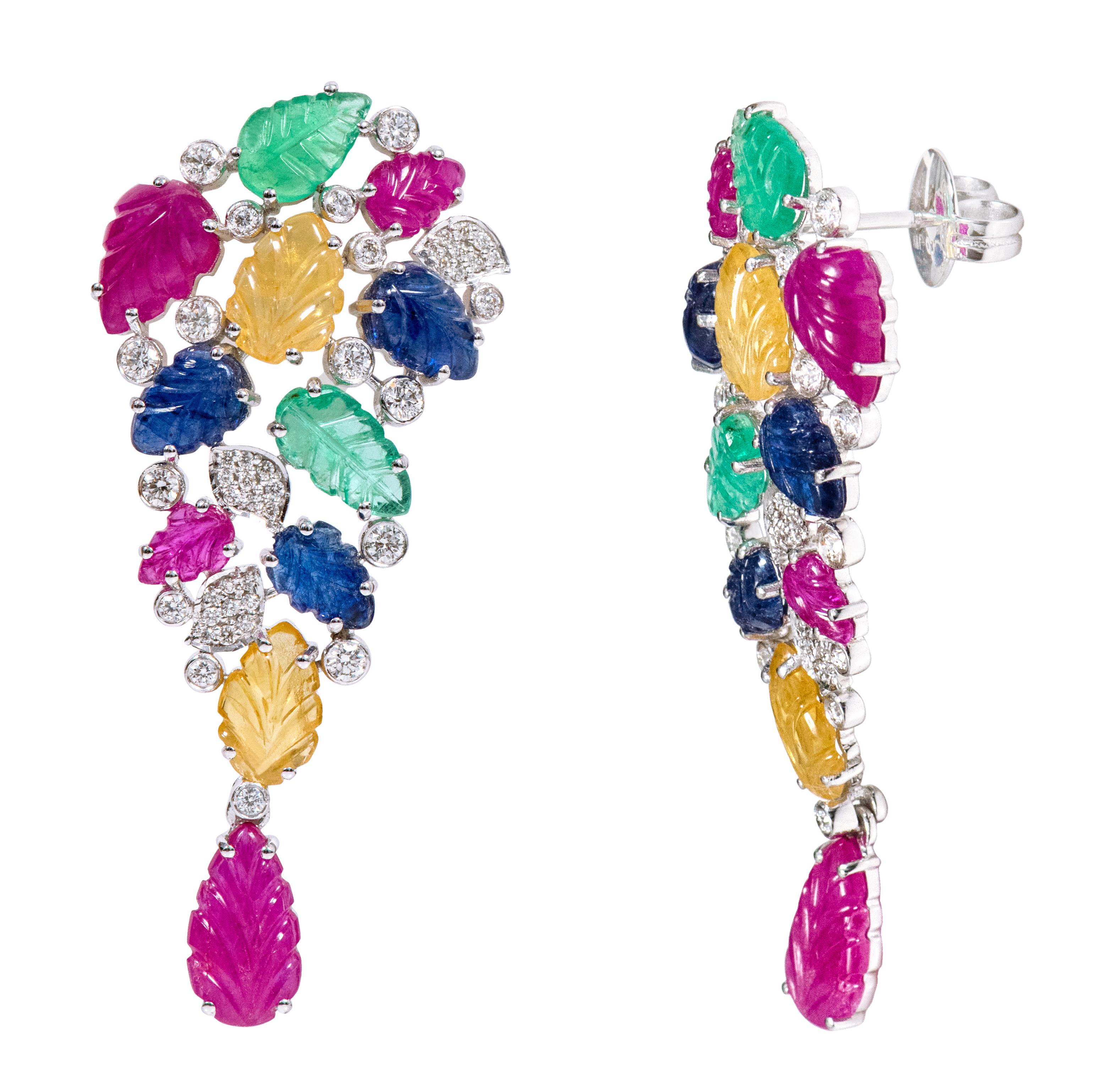 18 Karat White Gold 17.07 Carat Diamond and Carved Ruby, Sapphire, and Emerald Drop Earrings

This extraordinary mix of precious stone leaf carving and diamond long drop tutti-frutti earring is incredible. The beautiful combination of emerald, ruby,