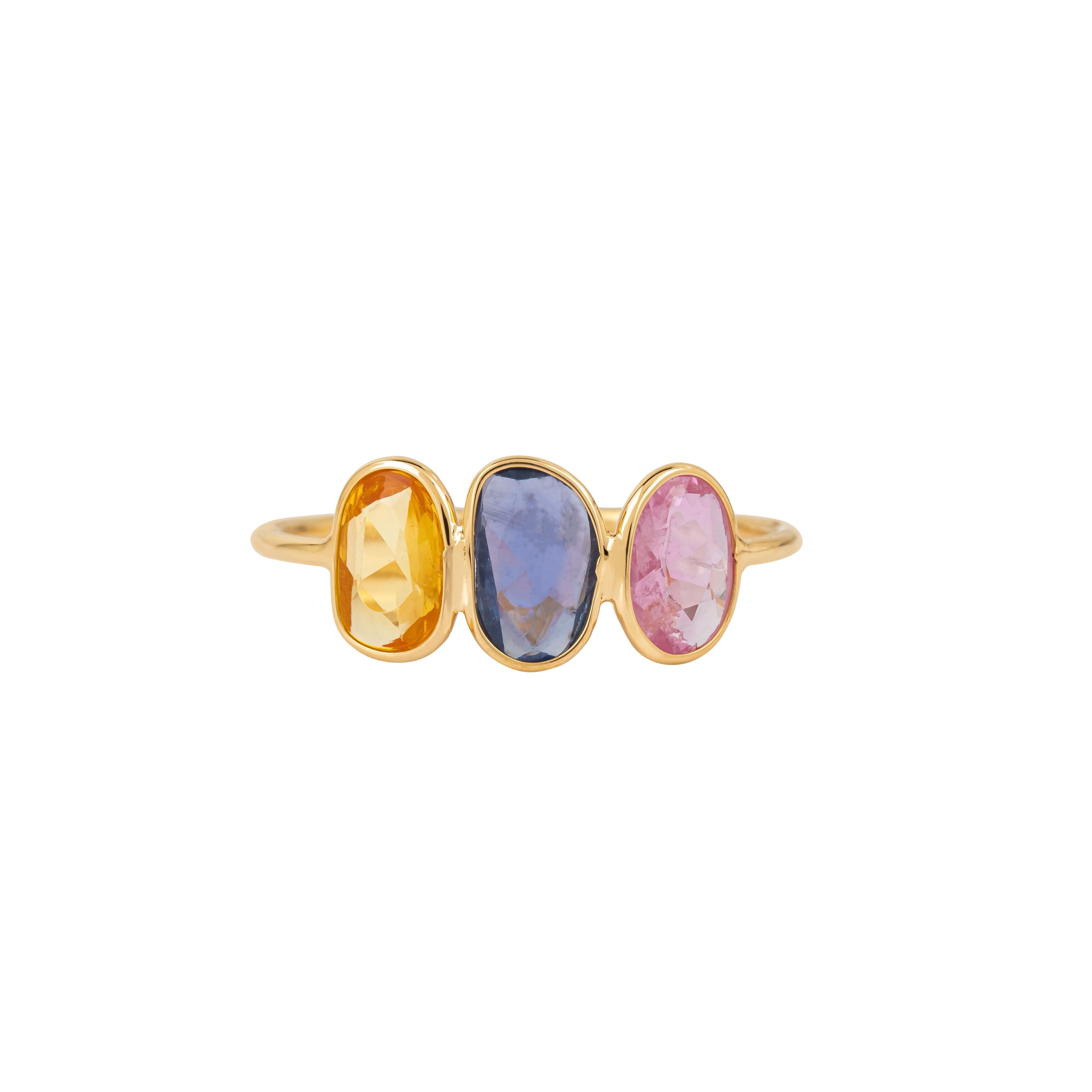 Three brilliantly colored sapphires form the heart of the 18 Karat Gold 1.95 Carat Multi-Sapphire Three Stone Ring, a piece that captures both elegance and vivid allure. With a total of 1.95 carats, each sapphire is selected for its rich hue,