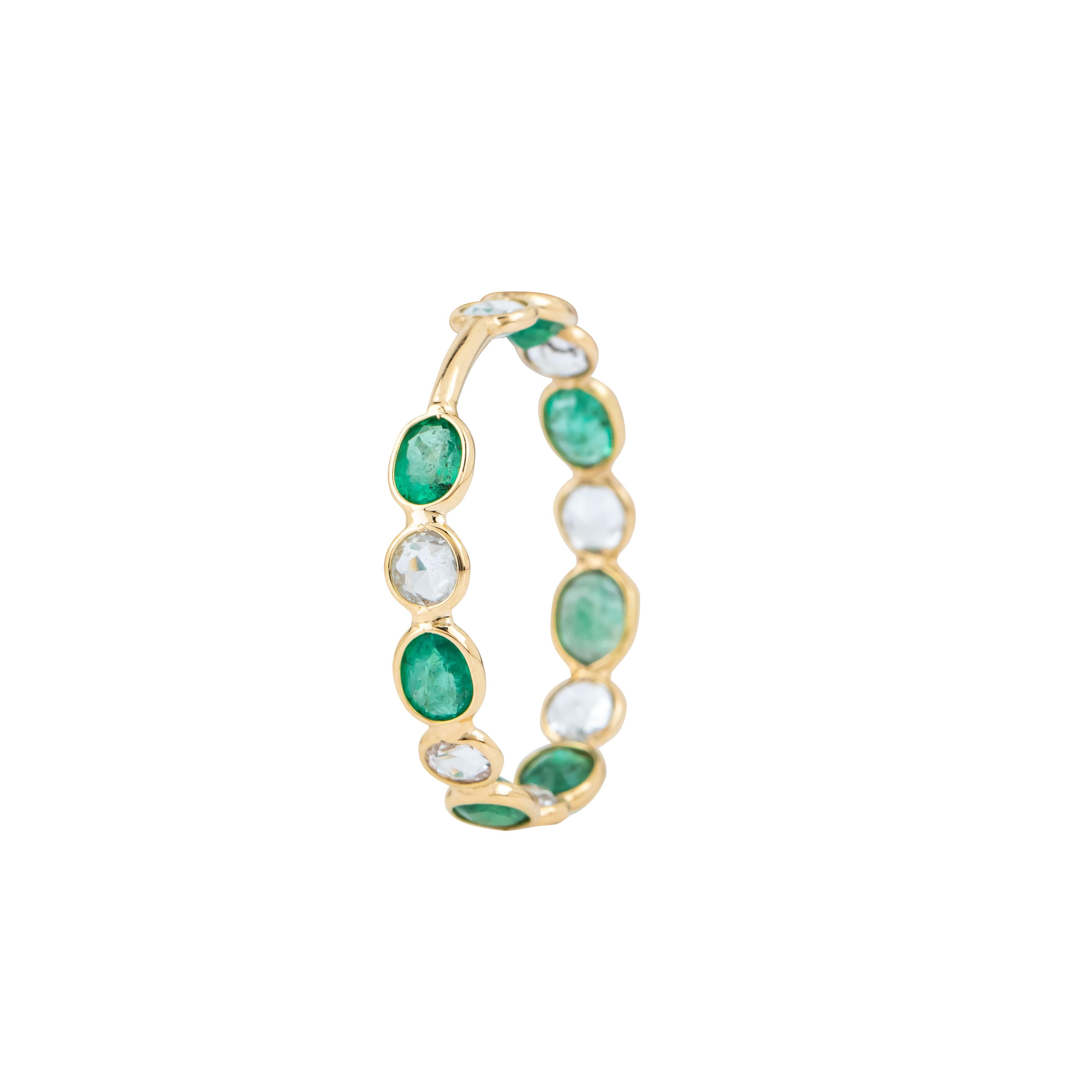 The 18 Karat Gold 1.95 Carat White Sapphires and Emerald Eternity Ring is a masterful fusion of elegance and timeless design. Its continuous band is set with alternating white sapphires and emeralds, each gemstone carefully selected for its