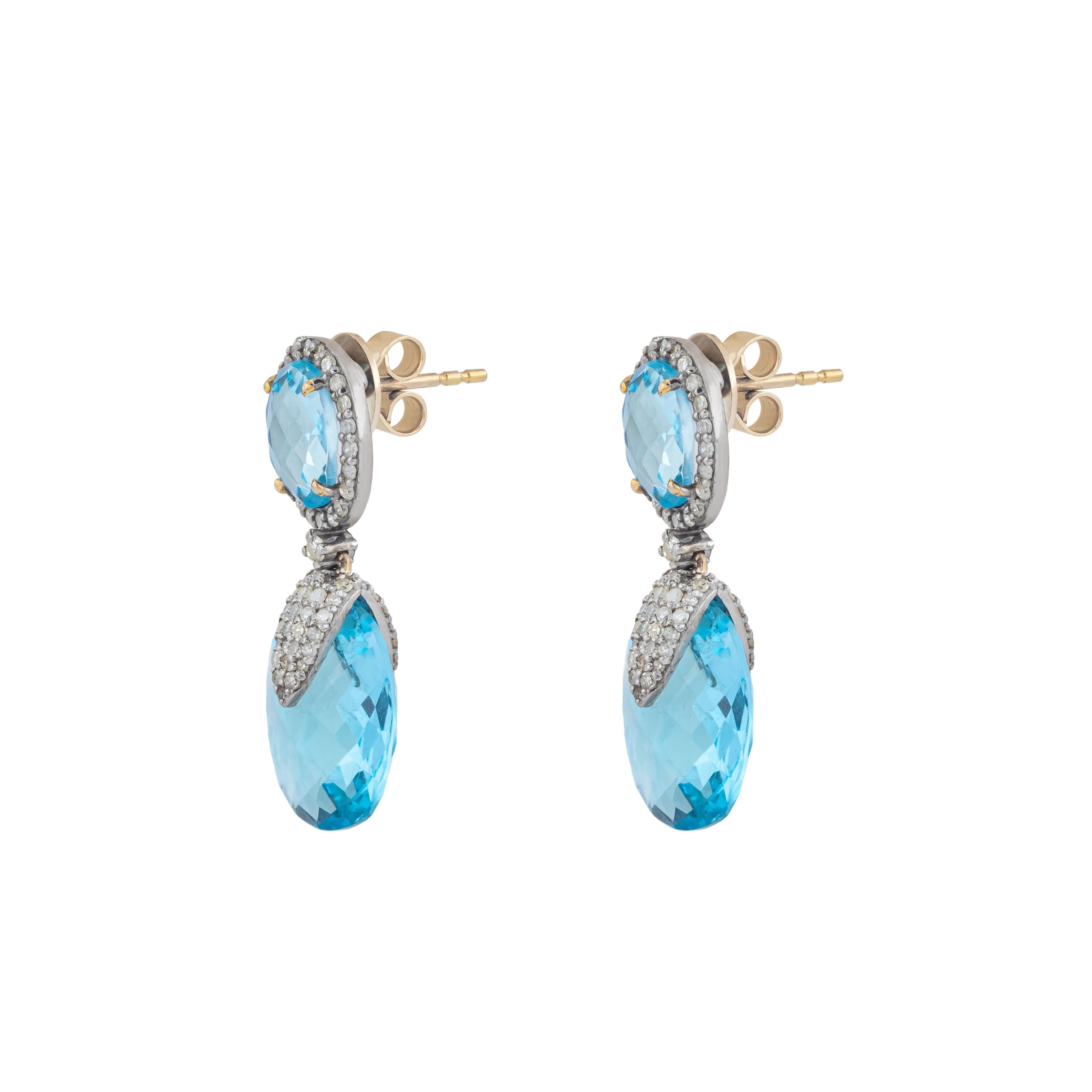 Elegance and sophistication define the 18 Karat Gold 23.25 Carat Diamond and Blue Topaz Drop Earrings. These meticulously crafted pieces blend luxurious materials with exceptional design, making them a remarkable addition to any jewelry