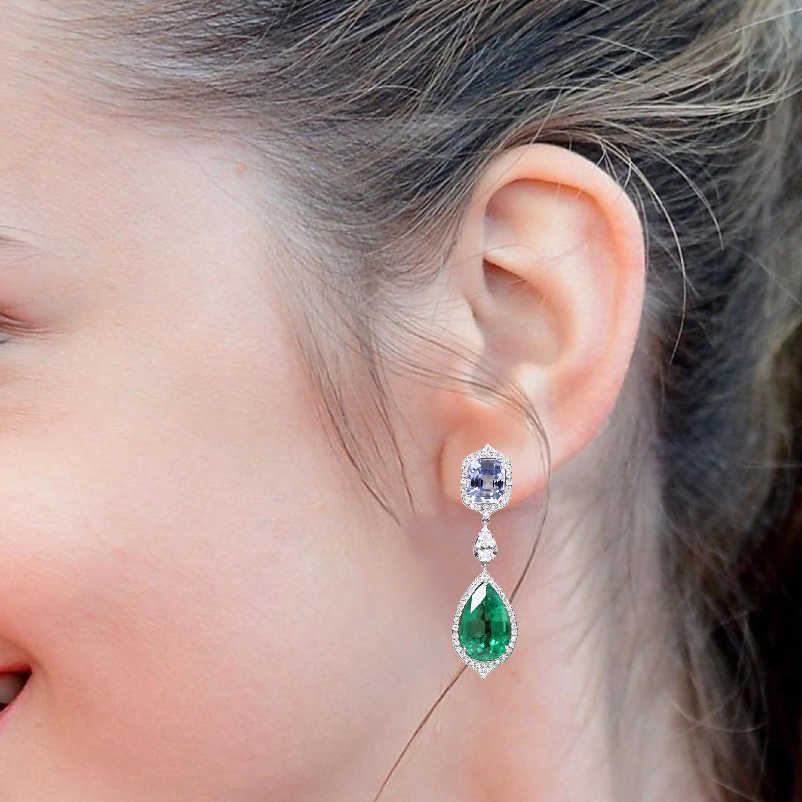 18 Karat White Gold 25.52 Carats Natural Emerald, Sapphire and Diamond Drop Earrings

The epitome of elegance, this striking pair of drop earrings exudes a timeless and stunning aura. The impeccable cushion-shaped Sapphire is surrounded by a single