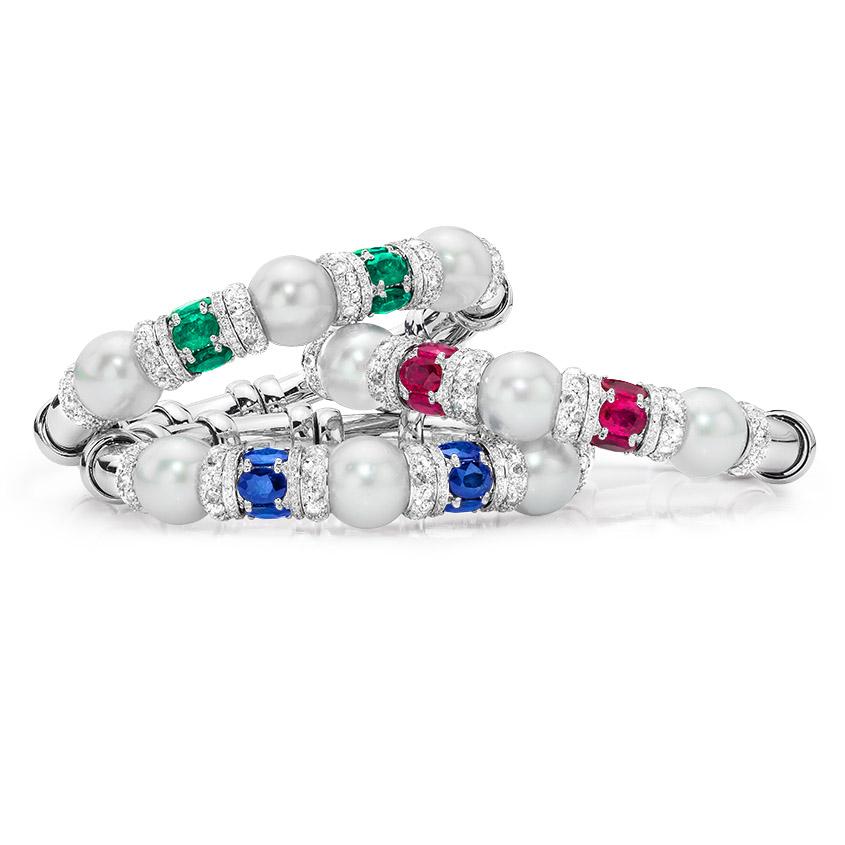 This elegant bracelet is set with 3 South Sea pearls and 6 oval-shaped  Rubies , accented with Diamond rondelles; set in 18-karat white gold. Flexible with open back.
Diamond weight: approximately 2.85 carats total. Ruby  weight: approximately 5.18