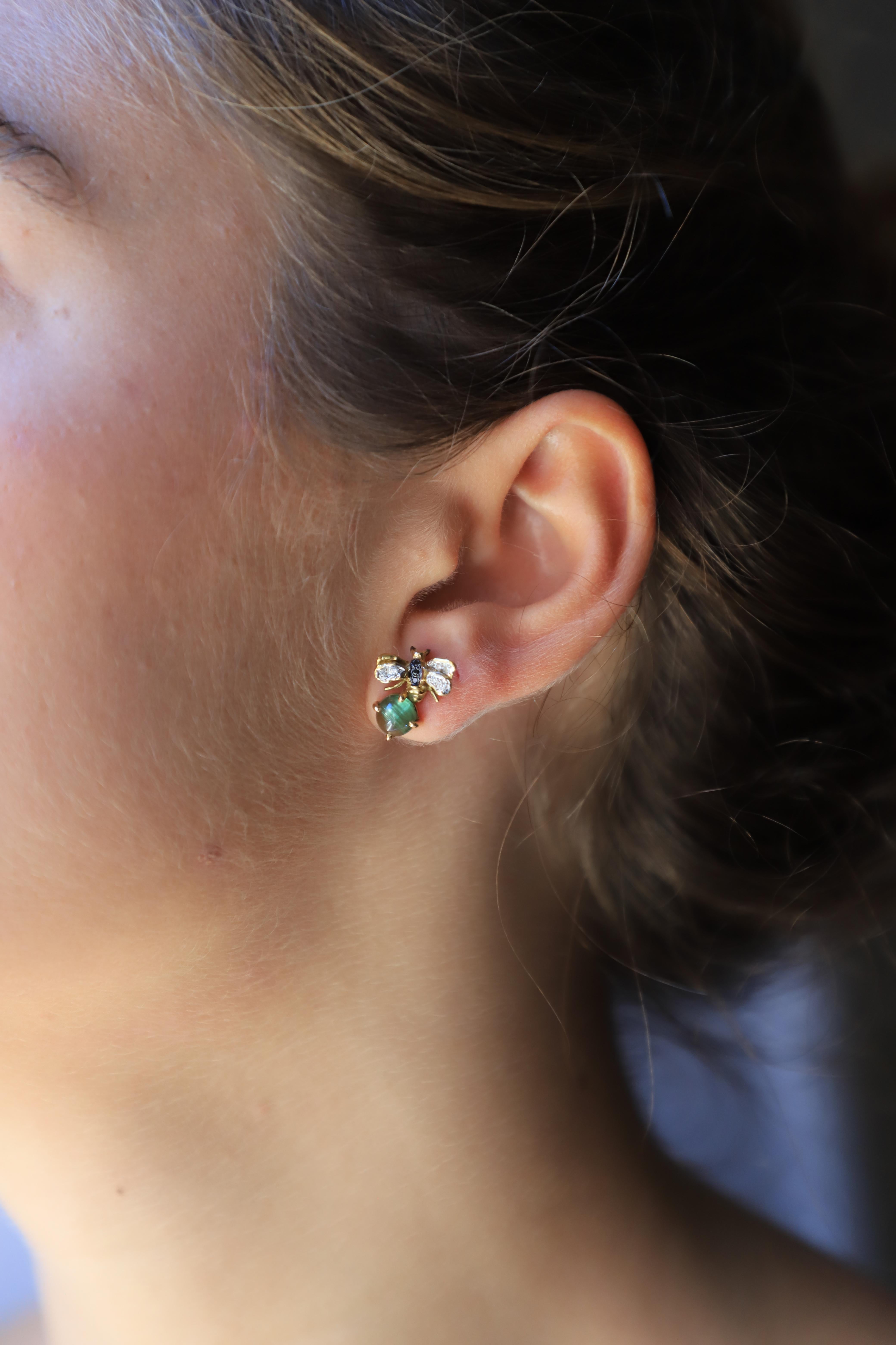 Rossella Ugolini Design Collection, a pair of Little Bees Stud Earrings handcrafted in 18 Karats Yellow Gold and adorned with a beautiful green Tourmaline stone, 0.10 carats White Diamonds and 0.06 karats deep Black Diamonds. 
Dimensions: 0.06 in.