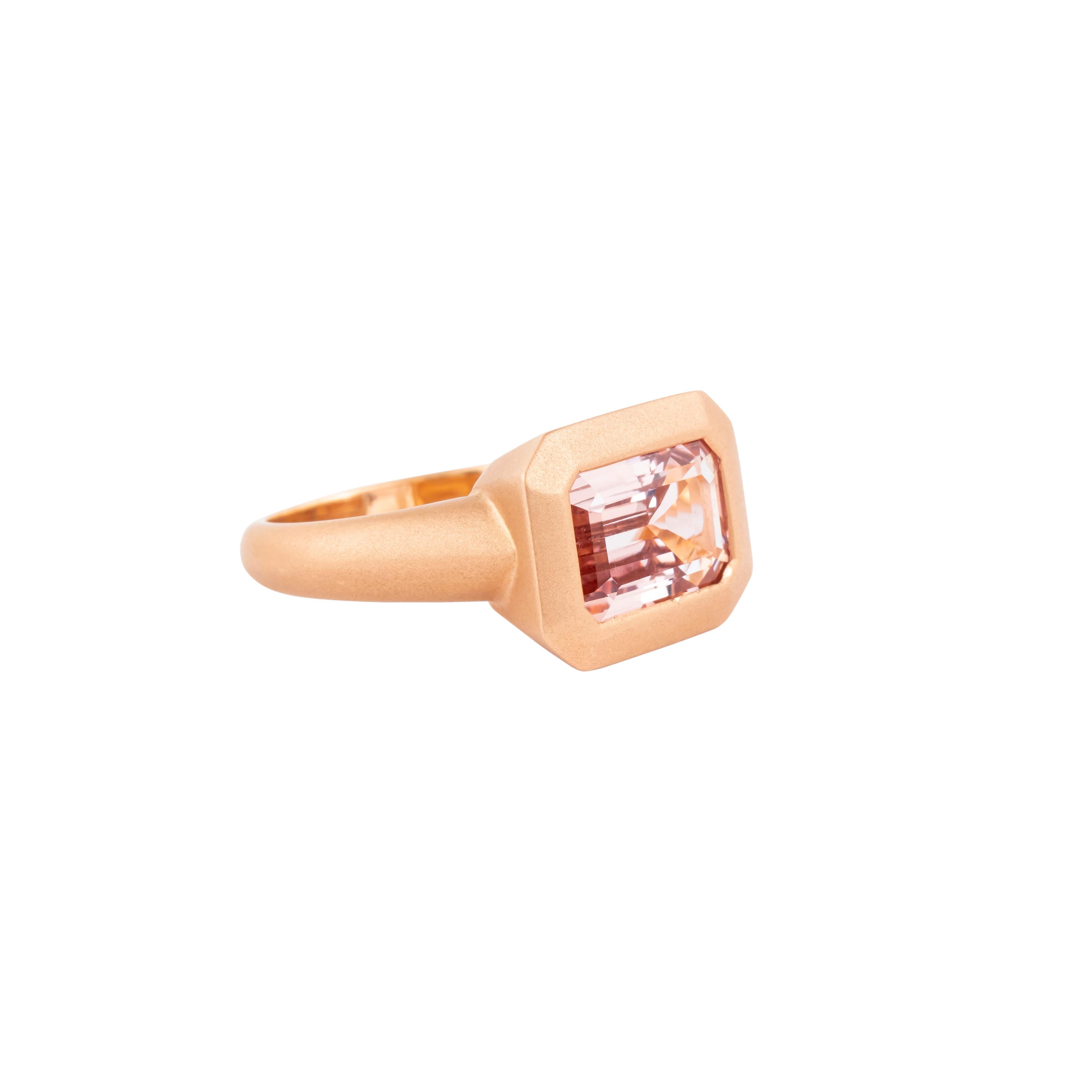 This 18 Karat Gold cocktail ring showcases a remarkable 3.58-carat morganite, a gemstone known for its delicate beauty and captivating clarity. The morganite is expertly cut to maximize its natural brilliance, allowing light to dance across its