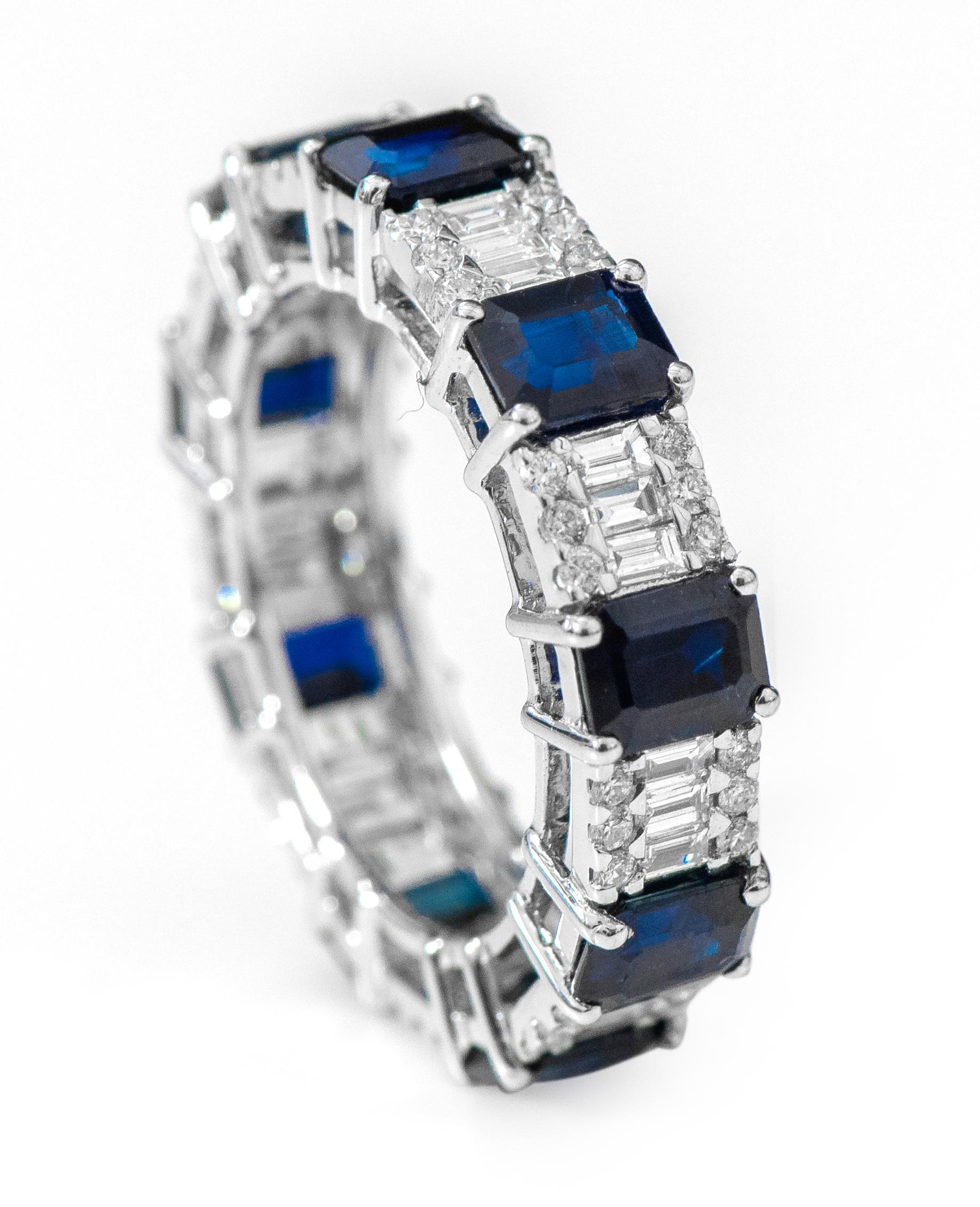 18 Karat White Gold 5.26 Carat Emerald-Cut Sapphire and Diamond Eternity Band Ring

This spectacular azure blue sapphire and invisible setting diamond band is breathtaking. The solitaire emerald cut matching and identically sized blue sapphires with