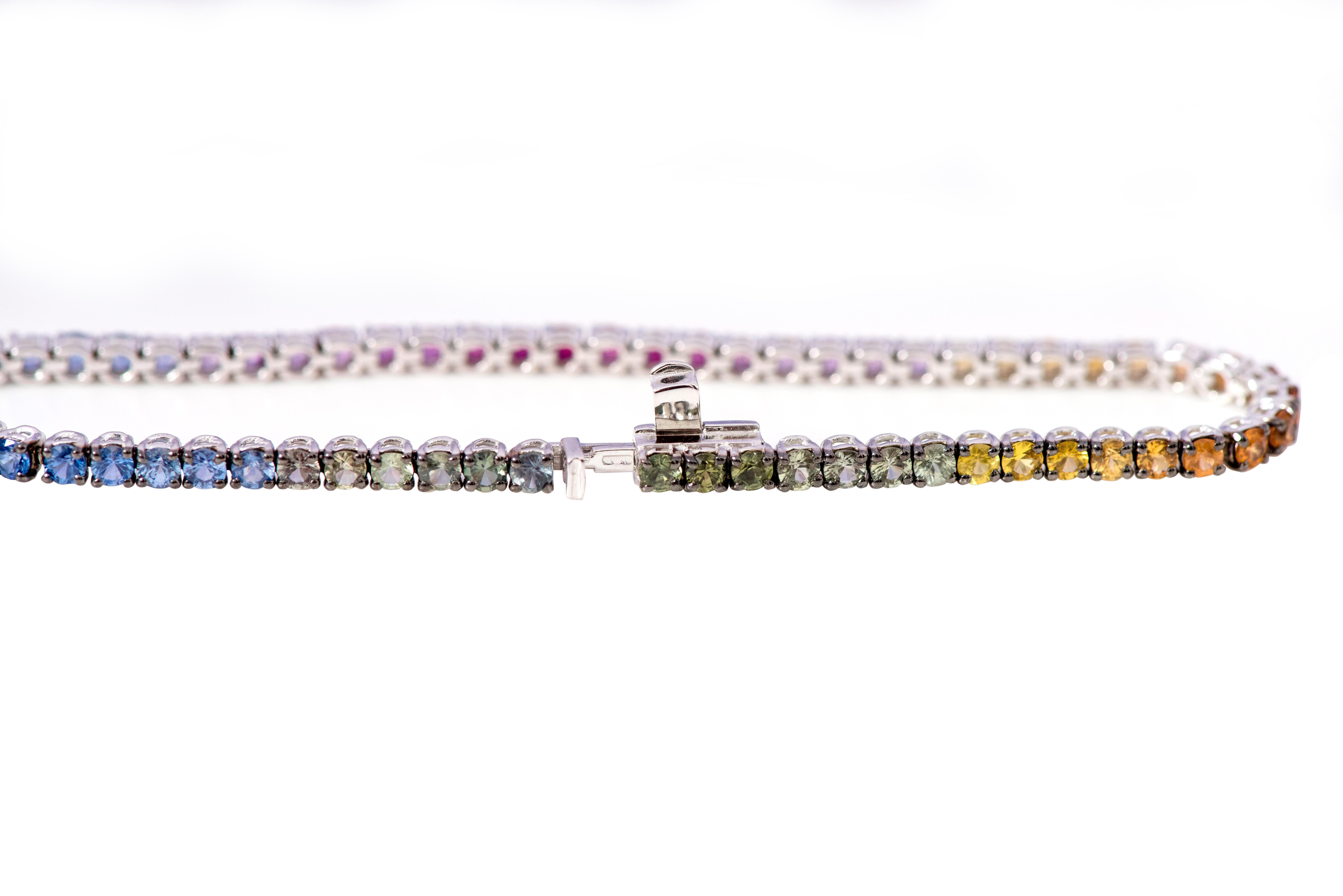 18 Karat White Gold 5.33 Carat Multi-Sapphire Rainbow Color Tennis Bracelet

This classy and elegant multi-sapphire thin tennis bracelet is eternal. The tennis bracelet with identical size round solitaire multi-sapphires with the perfect cut and