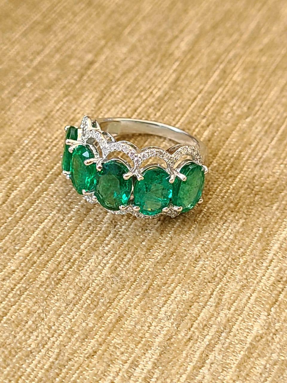 A very wearable Emerald and Diamonds Band Ring set in 18K Gold & Diamonds. The weight of the Emerald is 6.12 carats and is of Zambian origin. The Emeralds are completely natural, without any treatment. The weight of the diamonds is 0.45 carats. The