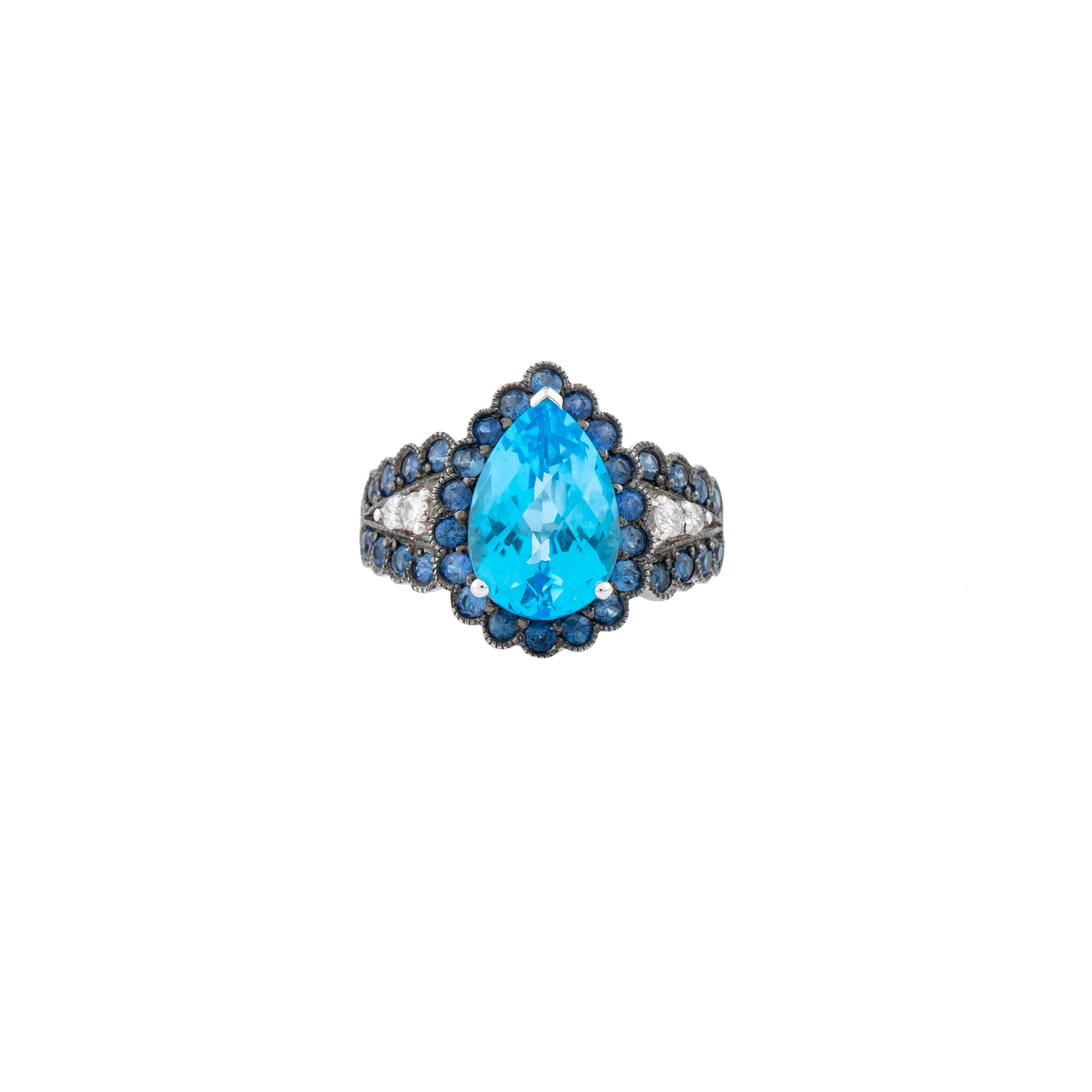A stunning embodiment of artistry and elegance, this 18 Karat Gold Color Stone and Diamond Cocktail Ring is a masterpiece of refined design. At its center, a 6.21-carat color stone takes the spotlight, showcasing its exquisite faceting and vibrant
