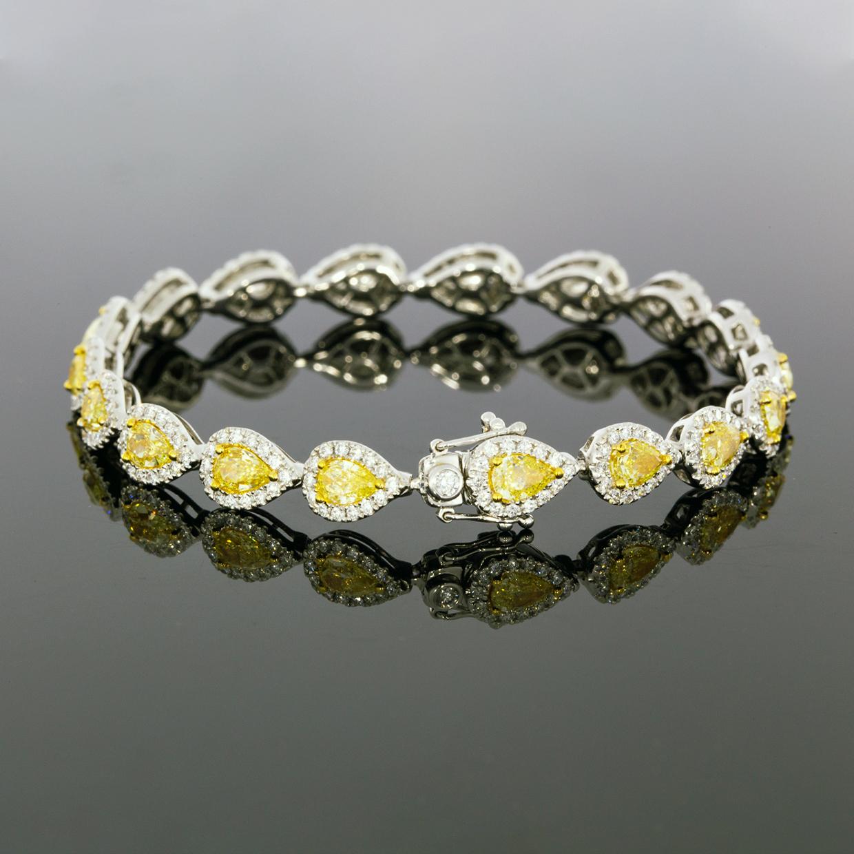 Put a little sunshine on your wrist with this gorgeous fancy yellow diamond halo bracelet. Featuring a unique design with brilliant fancy yellow pear shape diamonds surrounded by near colorless sparkly white diamonds, this bracelet is a