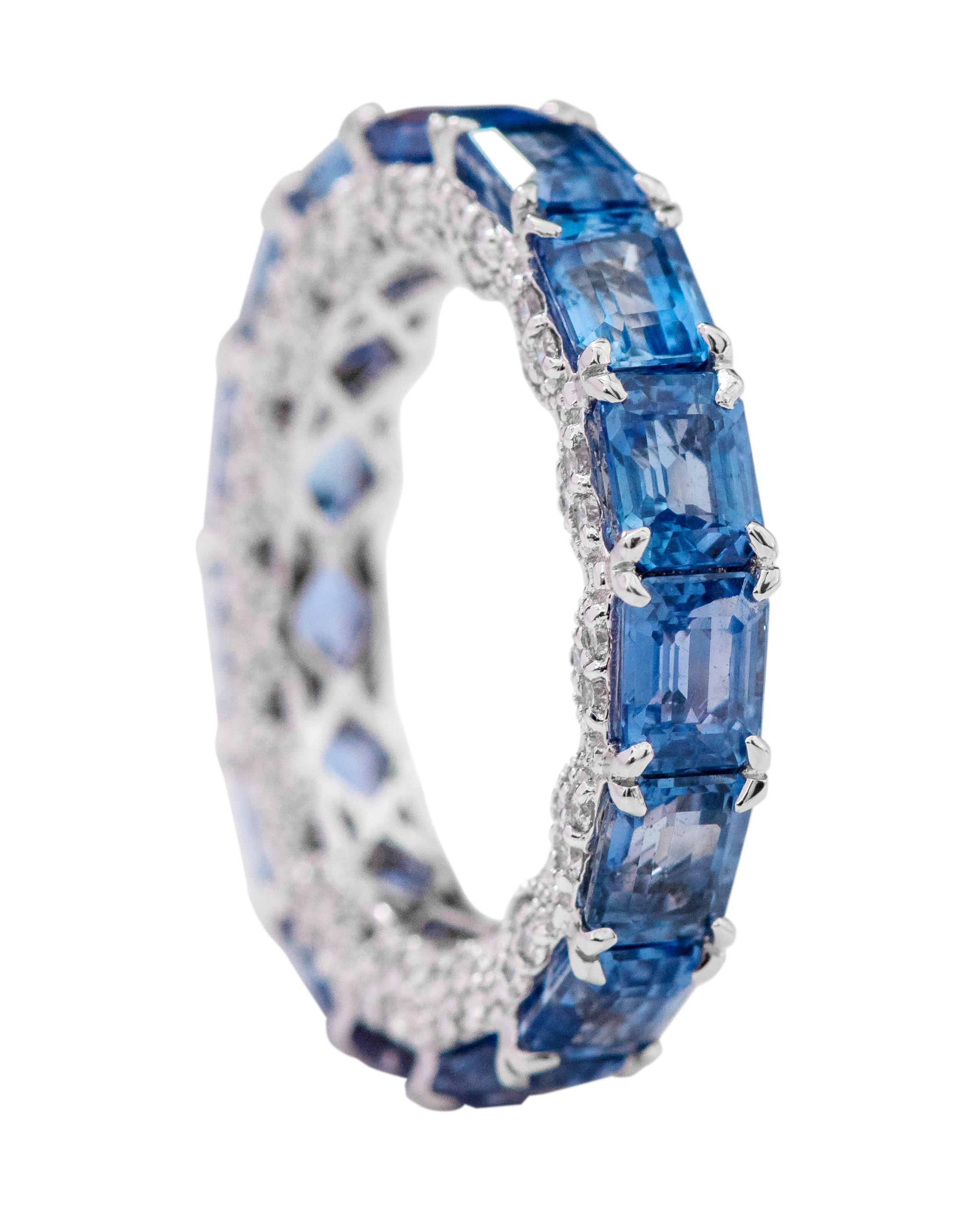18 Karat White Gold 8.81 Carat Emerald-Cut Sapphire and Diamond Eternity Band Ring

This impressive Prussian blue sapphire and side diamond band is breathtaking. The solitaire vertically placed emerald-cut sapphires in eagle prong white gold setting