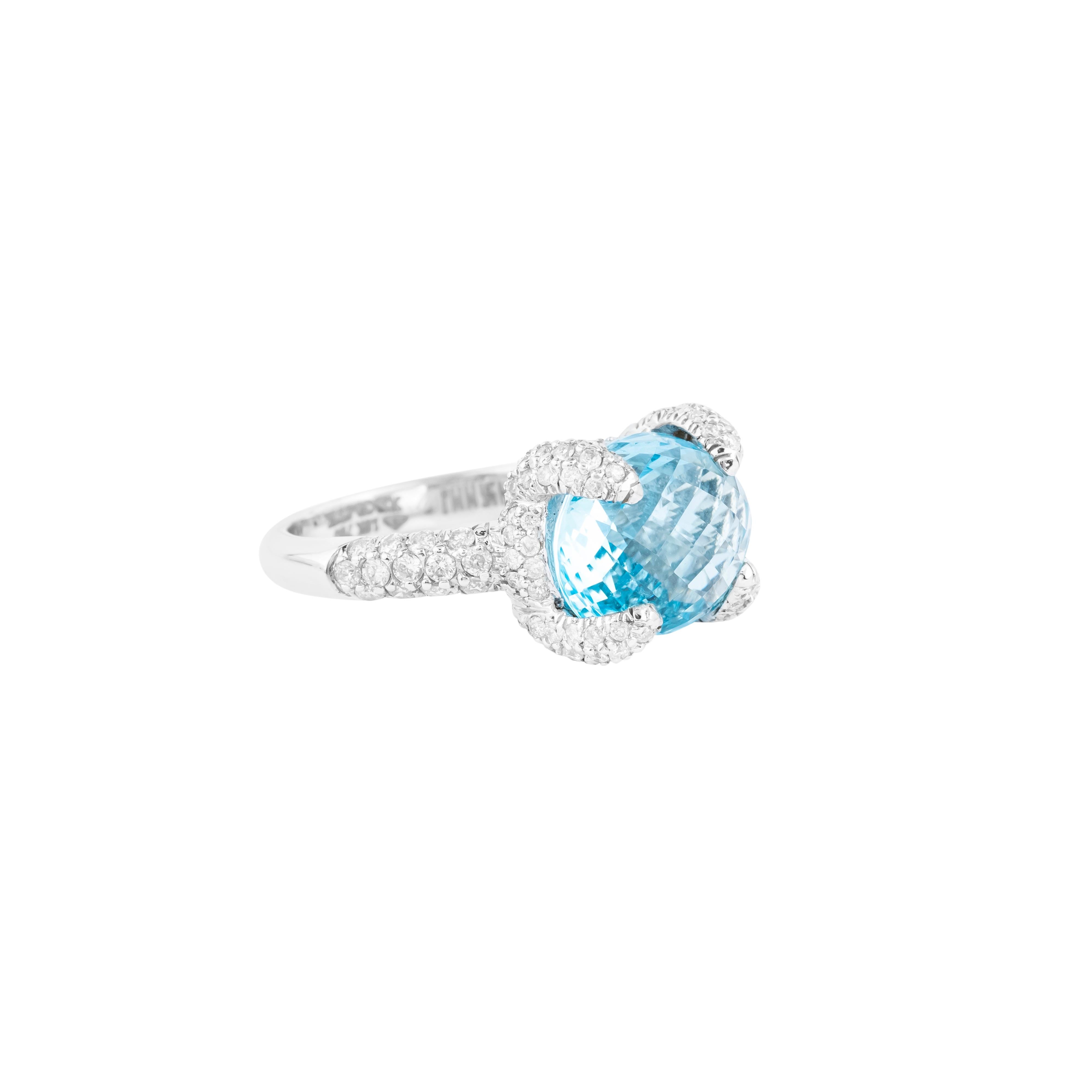 A harmonious blend of timeless simplicity and refined craftsmanship, this 18 Karat Gold Blue Topaz and Diamond Solitaire Ring is a stunning showcase of elegance. The centerpiece, a 9.26-carat blue topaz, is expertly cut to enhance its exceptional