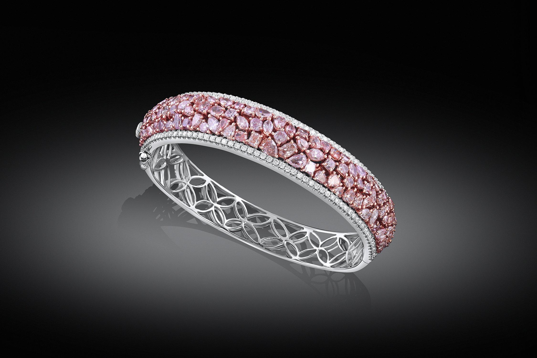 Pink Diamond Bangle. Natural colored fancy light pink to fancy pink multi-shape diamonds weighing 9.47cttw and colorless diamonds weighing 1.45cttw, set in an 18k white and pink gold bangle. GIA-certified.