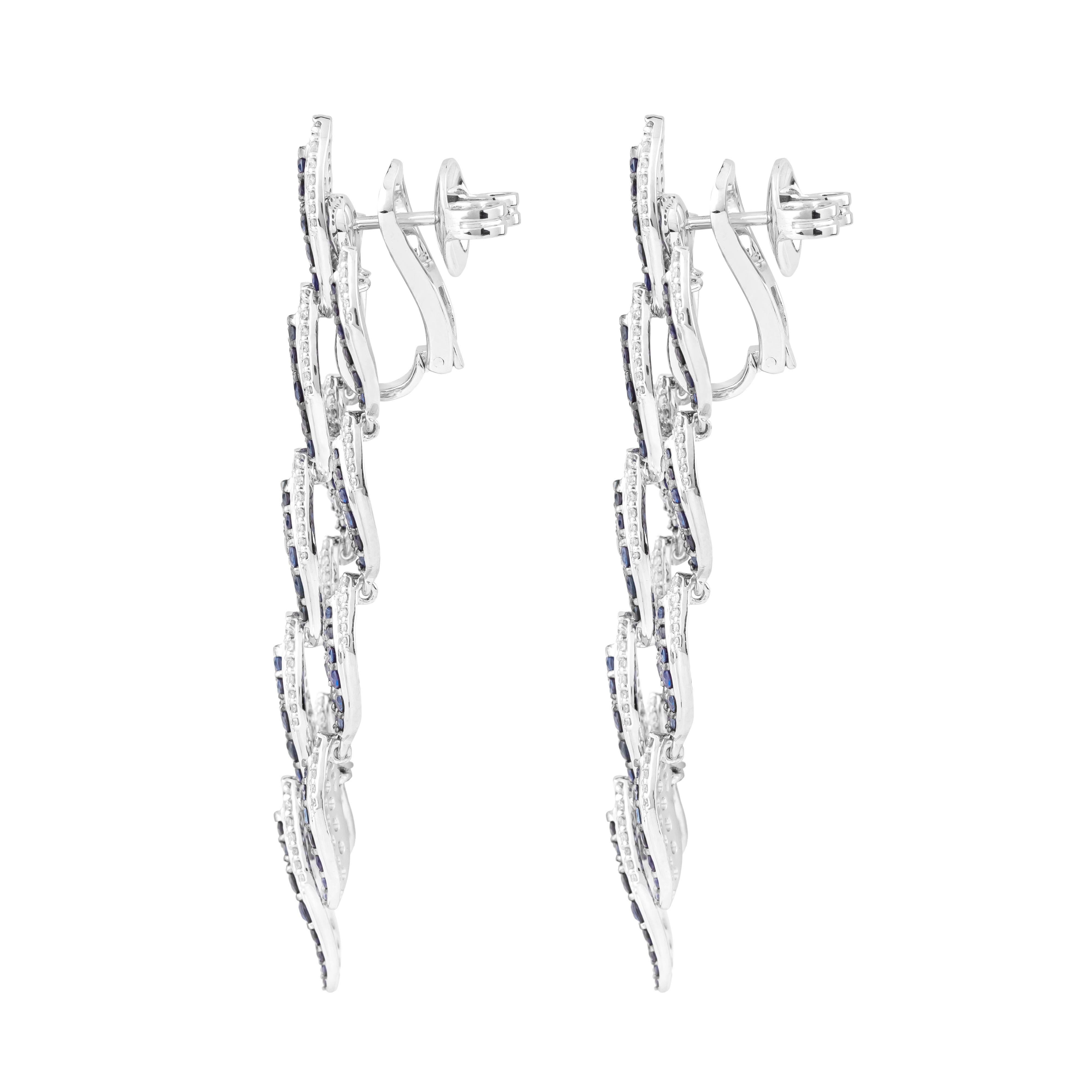 Embark on a journey of timeless elegance with our 18 Karat Gold 9.9 Carat Blue Sapphire & Diamond Chandelier Earrings, where sophistication meets extravagance in a captivating display of opulence. Each pair is meticulously crafted and uniquely
