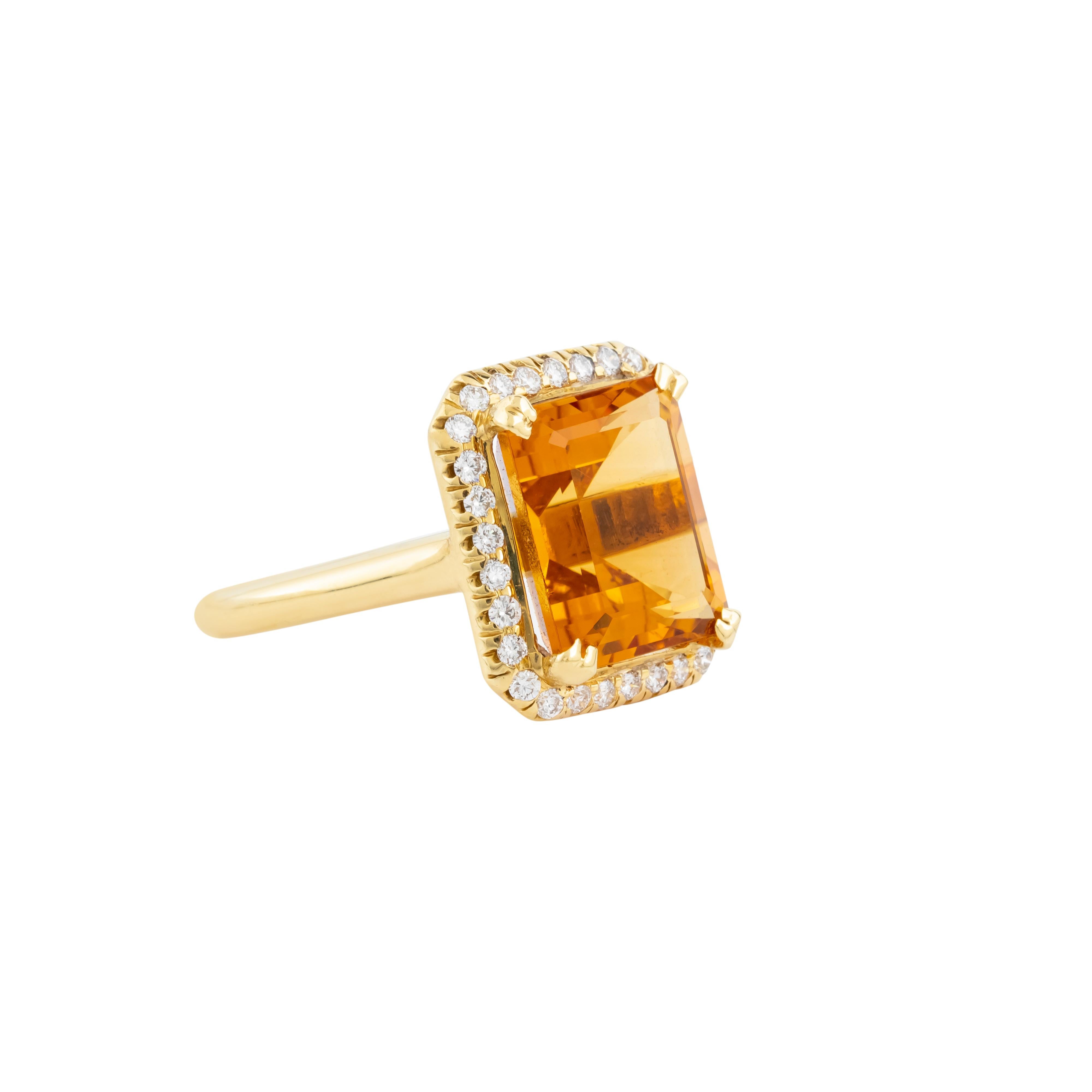 This 18 Karat Gold Modern Ring is an embodiment of refined craftsmanship and contemporary elegance, featuring a 9.98-carat golden topaz as its stunning focal point. The gemstone is meticulously cut to reveal a brilliant, multifaceted surface that