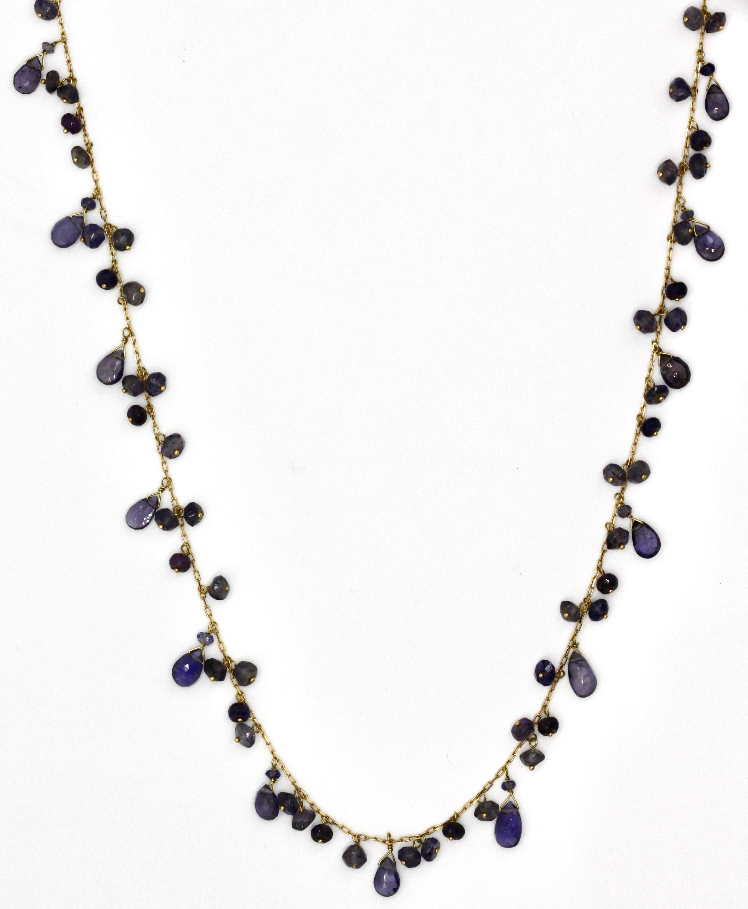 18 Karat Gold and Amethyst Necklace
The necklace composed of multiple amethyst beads, spaced at intervals by textured gold links , length 27 inches.