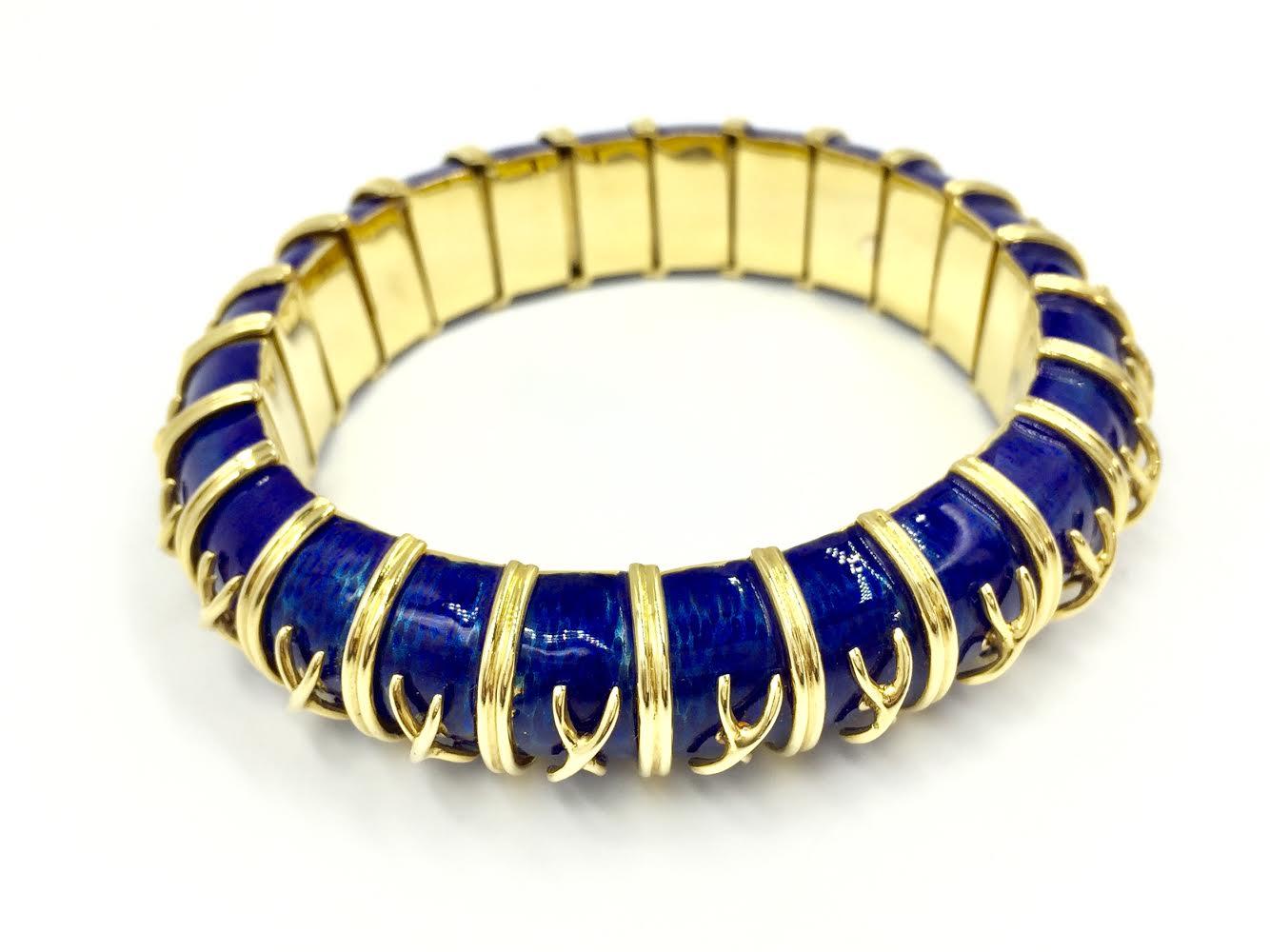 Exquisite bracelet designed by Michael Gates (M. Gates) using vibrant, royal blue enamel with an 18k yellow gold X design on each link. Enamel is in near pristine condition over the entire bracelet. This bracelet is a flexible, slightly domed bangle