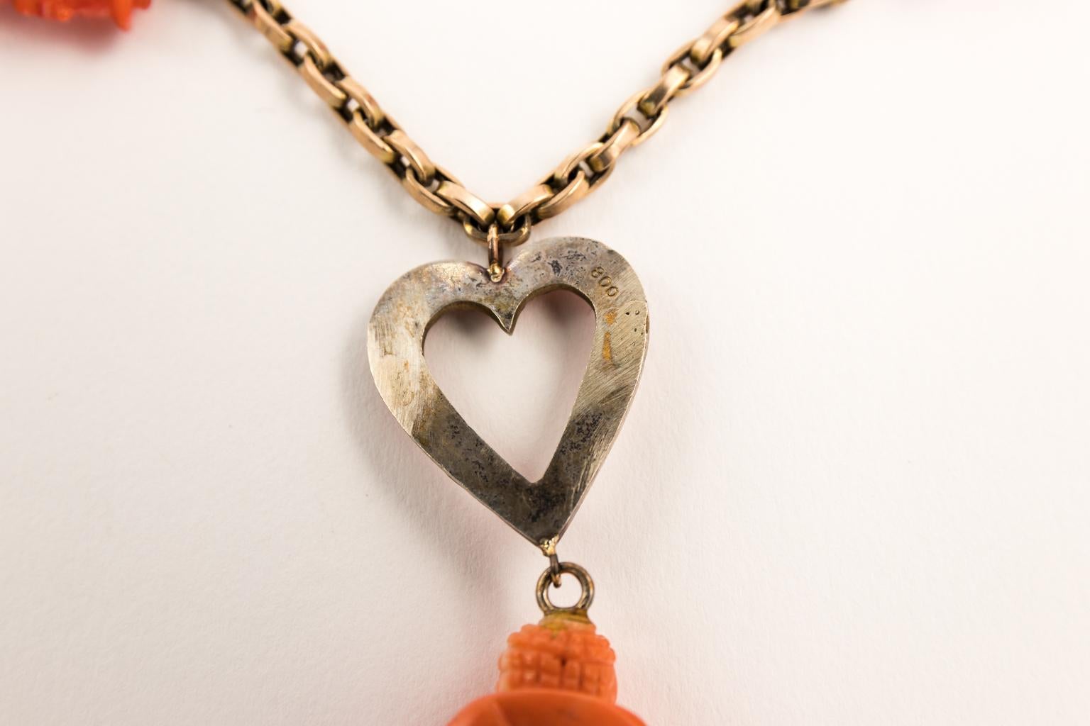 Circa 1950s Sardinian coral charm necklace with dog, cat, pug, bunny, heart and center Buddha charms.
