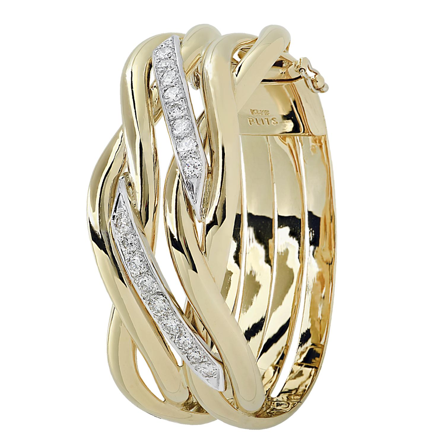 Striking bangle bracelet crafted in 18 karat yellow and white gold, featuring round brilliant cut diamonds weighing approximately 2.25 carats total, G color, VS-SI clarity. Four gold strands swirl around the wrist, weaving and intertwining, detailed