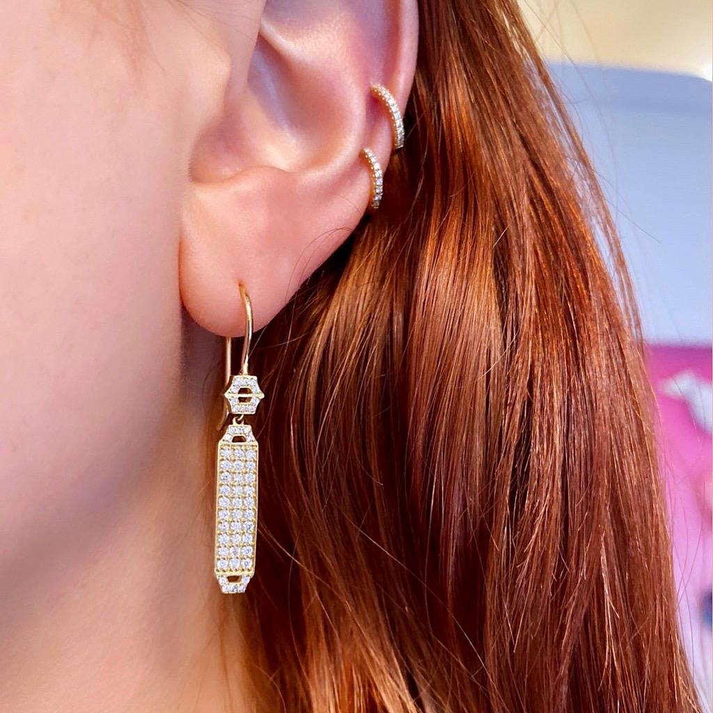 Deco Inspired gold and diamond pave drop earrings which are both modern, yet classical. An elegant, elongated shape encrusted with diamonds, these earrings are perfect for day to night dressing.
Materials: 18 karat gold, 1.3mm, 1.0mm diamonds