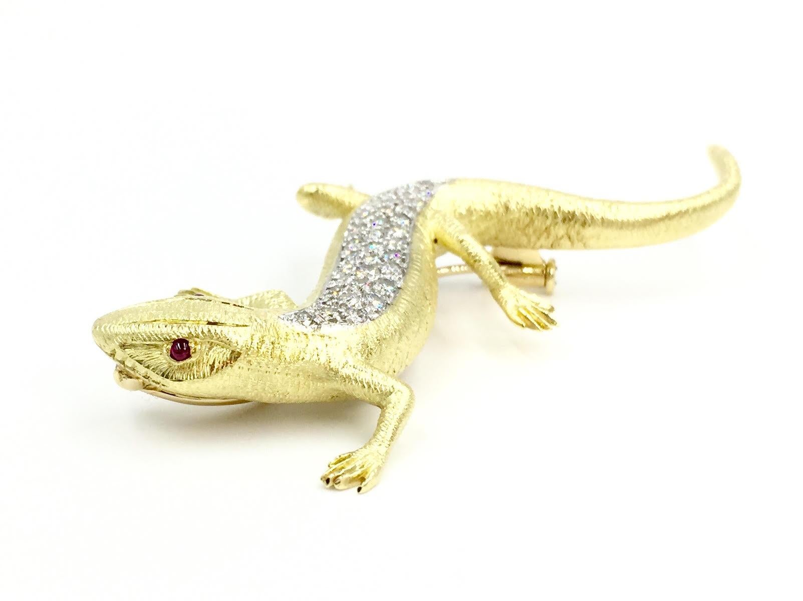 Created by E. Wolfe and Company, manufacturer of exquisite and whimsical designed animal brooches and fine jewelry since 1850. This 18 karat gold detailed lizard brooch features .71 carats of high quality diamonds, pavé set in white gold to give