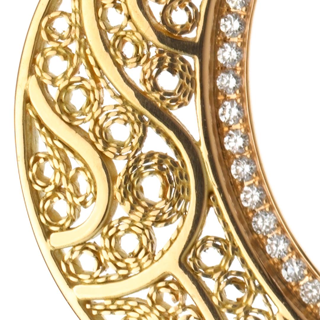 18 karat Yellow Gold and pave-set Diamond Filigree Crescent Moon & Stars Earrings. 

A marriage of the cosmos, celestial stars and a crescent are tied together in an eternal bond. Having apprenticed in Cairo's famed Khan-el-Khalili Bazaar, Azza