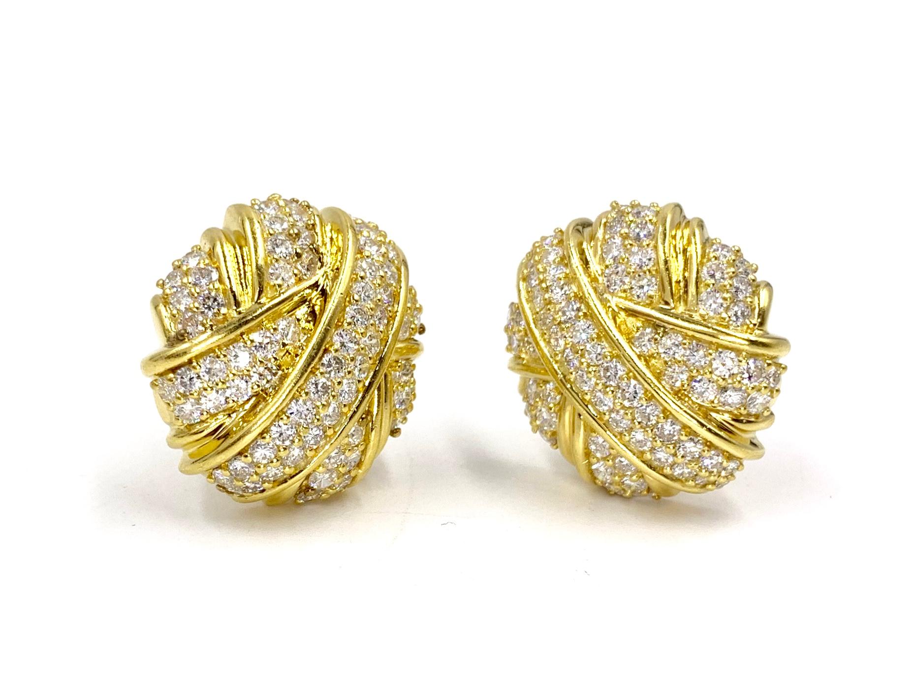 Simply exquisite slightly oval shaped button clip-on earrings featuring 4.65 carats of high quality round brilliant diamonds at approximately F color, VS2 clarity. Earrings feature a stylish overlay pattern with two rows of diamonds in each section