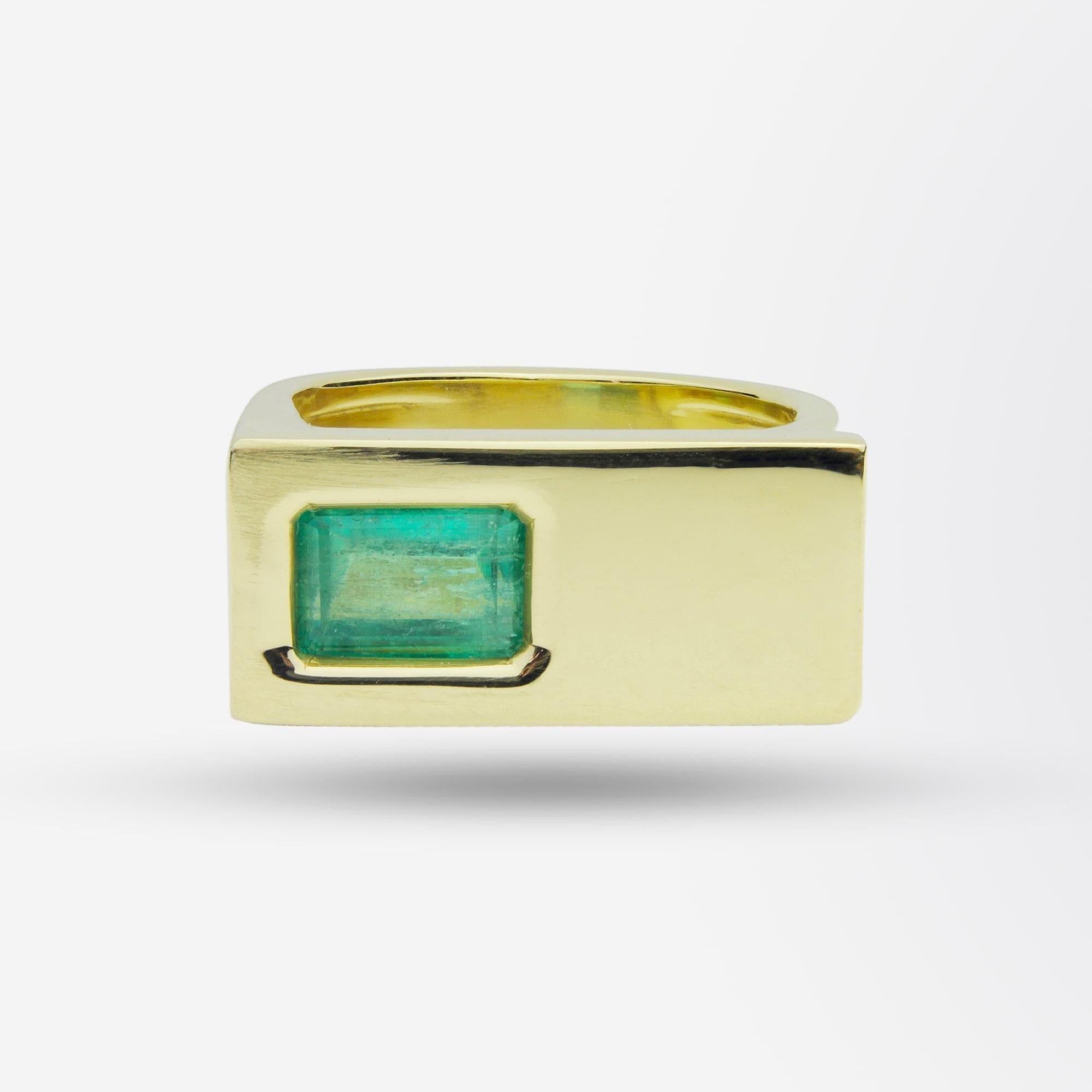 A heavy 18kt yellow gold ring set with a substantial octagonal cut, 2.02ct emerald. The ring is modernist in design and features sleek clean lines and crisp angles. The emerald is 'back set' which assists in avoiding direct knocks and abrasions to