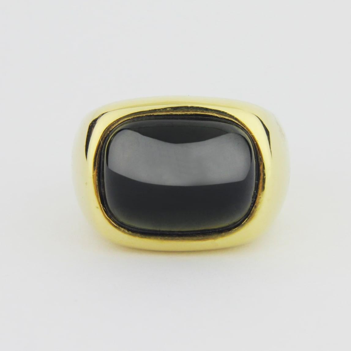 An Italian 18kt yellow gold and cabochon green tourmaline dress ring. Beautifully made, this ring features a deep green tourmaline estimated to be 10 carats in size, which has been set in a rub over style. The piece has been signed to the outside of