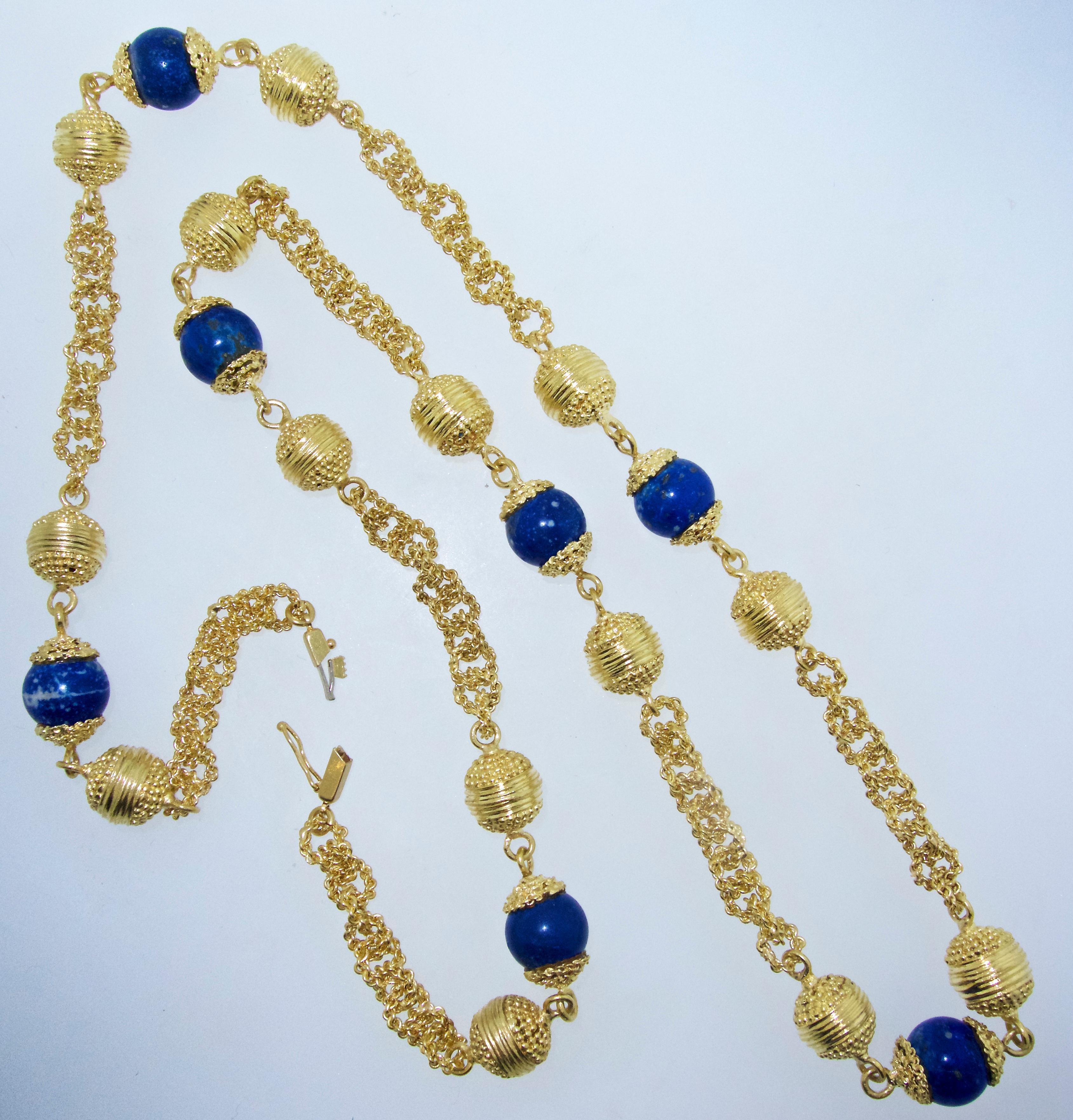 Long necklace of 18K yellow gold and 7 fine natural lapis lazuli beads - all a vibrant blue and well matched and 11 mm in diameter.  This necklace chain is 32 inches long and weighs 147 grams.    The handmade links are very ornate and unusual.  This