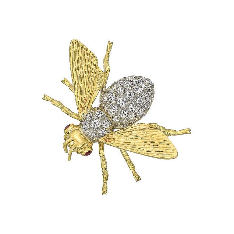 Vintage bee pin, featuring a pavé-set diamond body and abdomen with polished 18k yellow gold head, wings and legs, as well as ruby eyes.

36 brilliant-cut diamonds weighing ~1.44 total carats (G-H color, VS1-VS2 clarity)
Two cabochon rubies weighing