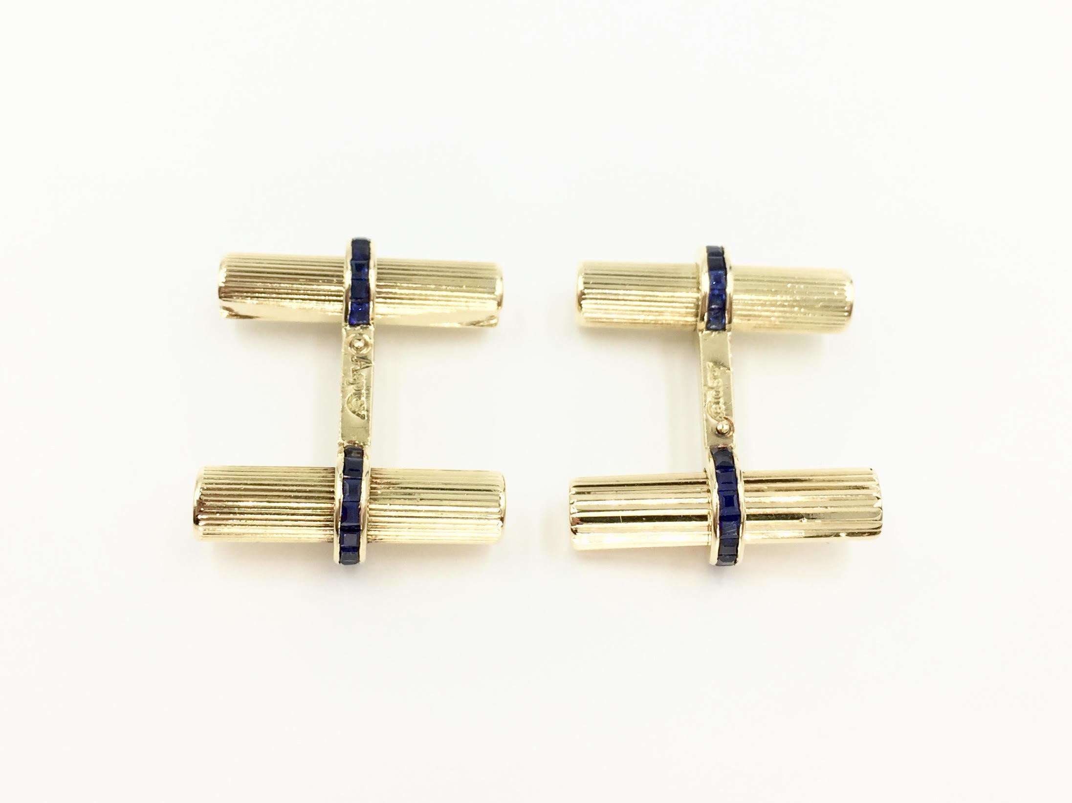 Signed Asprey solid 18 karat yellow gold cuff links featuring beautiful quality channel set french cut sapphires, circa 1940. Each tubular bar of the cuff link is expertly grooved giving these an extraordinary sheen, reflecting light beautifully.