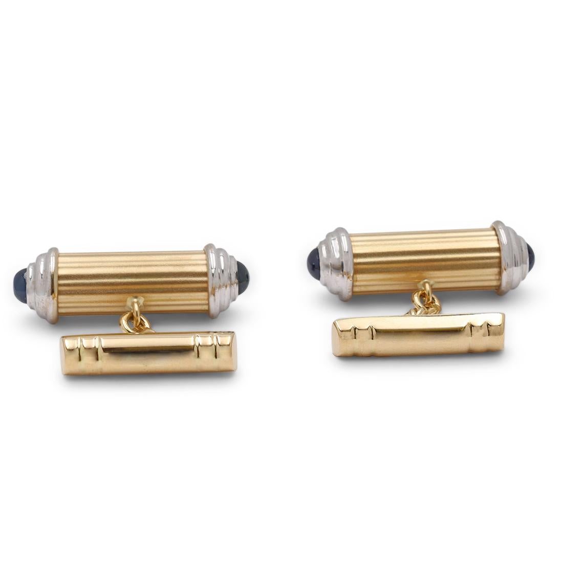 A pair of cufflinks crafted in 18 karat white and yellow gold. Ribbed matte gold cylinders are capped with white gold ends and finished with cabochon sapphires. Cufflinks are presented without box and papers. CIRCA 1980s.

Box: No
Papers: No